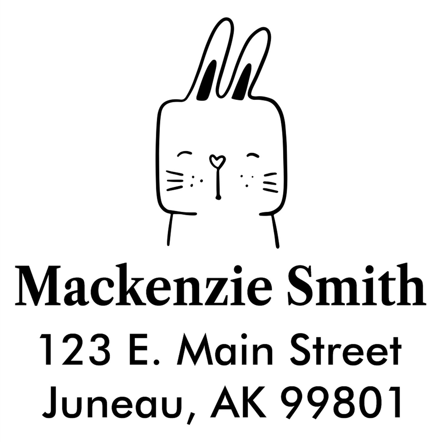 Self-Inking Cartoon Animal Fuzzy Rabbit Personalized Address Stamper featuring a cute rabbit illustration above the name "Mackenzie Smith" and address "123 E. Main Street, Juneau, AK 99801." This Custom-Made Address Stamper adds charm to mail.