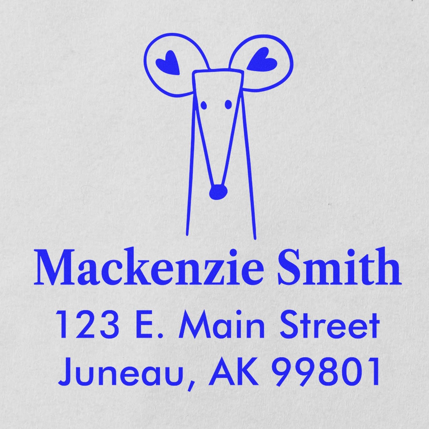 Portable Pre-Inked Mighty Mouse Made To Order Return Address Stamp featuring a blue mouse design with heart-shaped ears. Custom New Address Stamper displays 'Mackenzie Smith, 123 E. Main Street, Juneau, AK 99801' in blue text on a white background.
