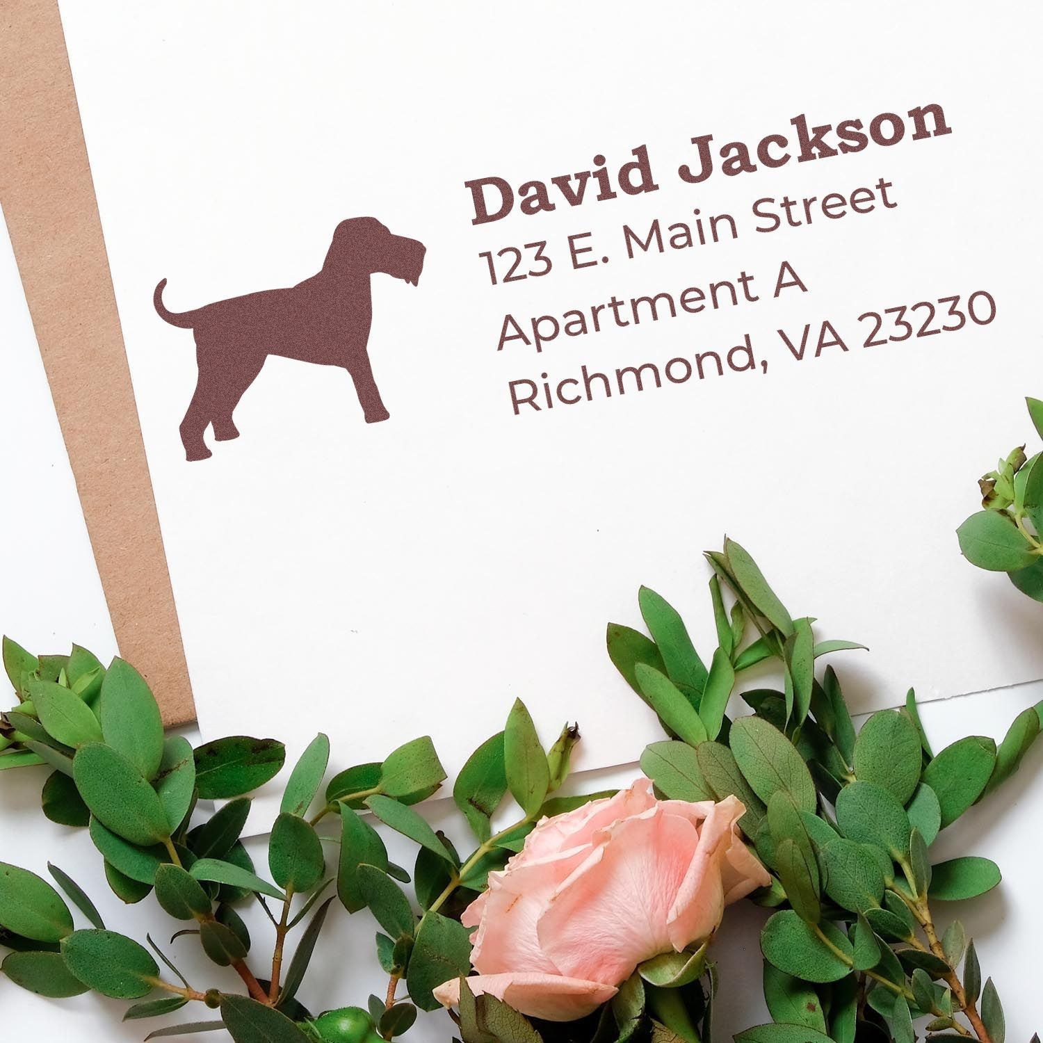 Self-Inking Airedale Terrier Dog Address Stamp on an envelope with a silhouette of a dog, surrounded by green leaves and a pink rose.