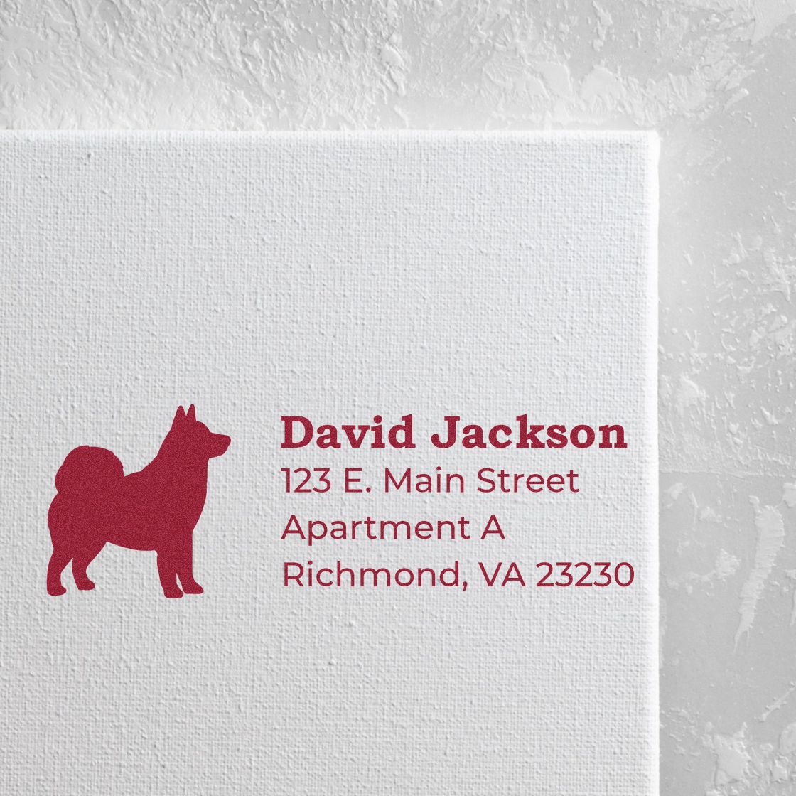 Self-Inking Alaskan Malamute Dog Address Stamp on white paper, featuring a red silhouette of a dog and sample address text in bold red font.