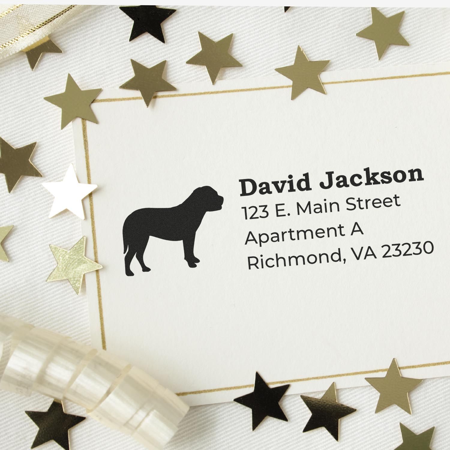 Slim Pre-Inked Bullmastiff Address Stamp on a card with gold stars and ribbon, featuring a silhouette of a Bullmastiff and sample address text. Perfect for personalized stationery.