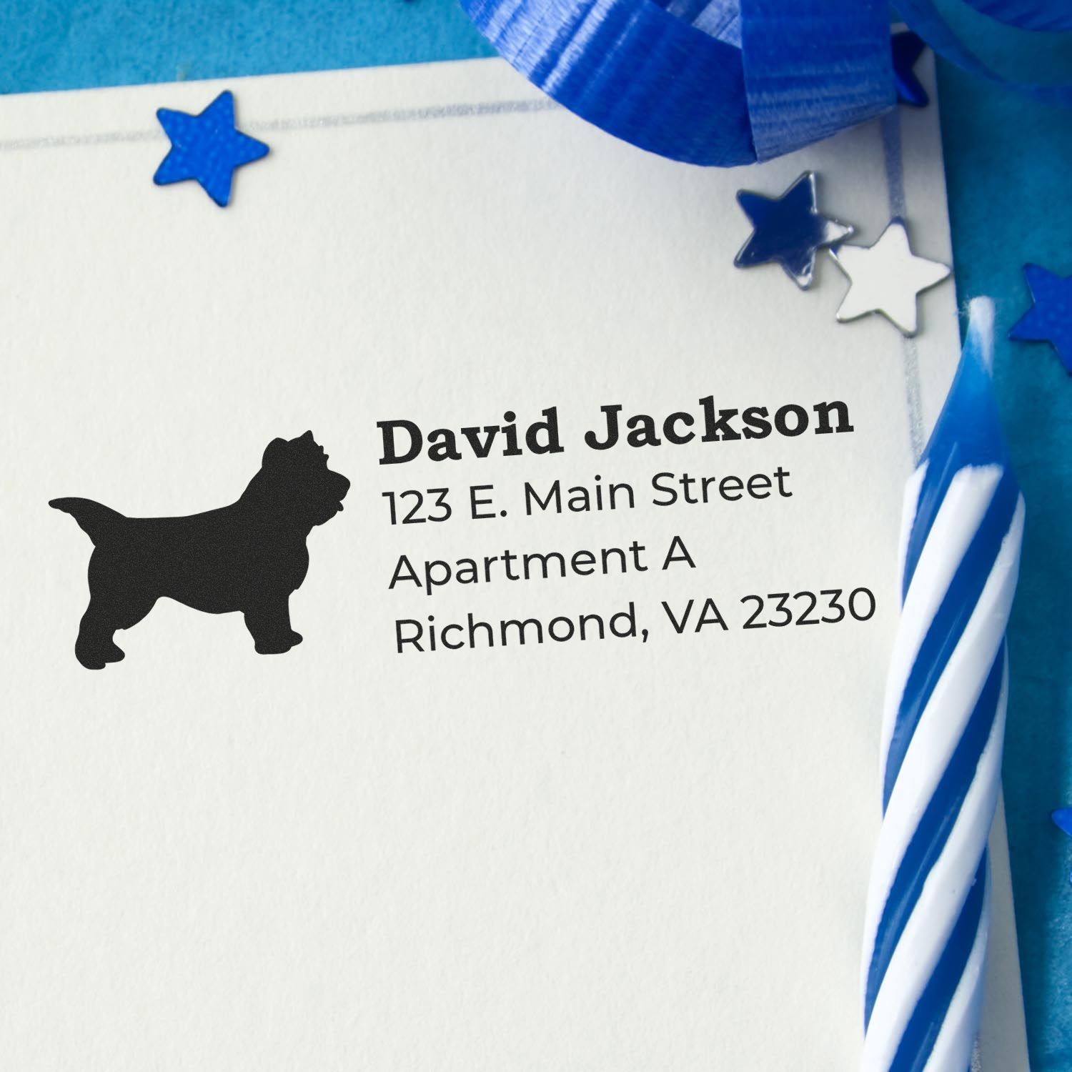 Cairn Terrier Silhouette Address Rubber Stamp on an envelope with blue stars and a striped candle, showcasing a personalized address in bold black text.