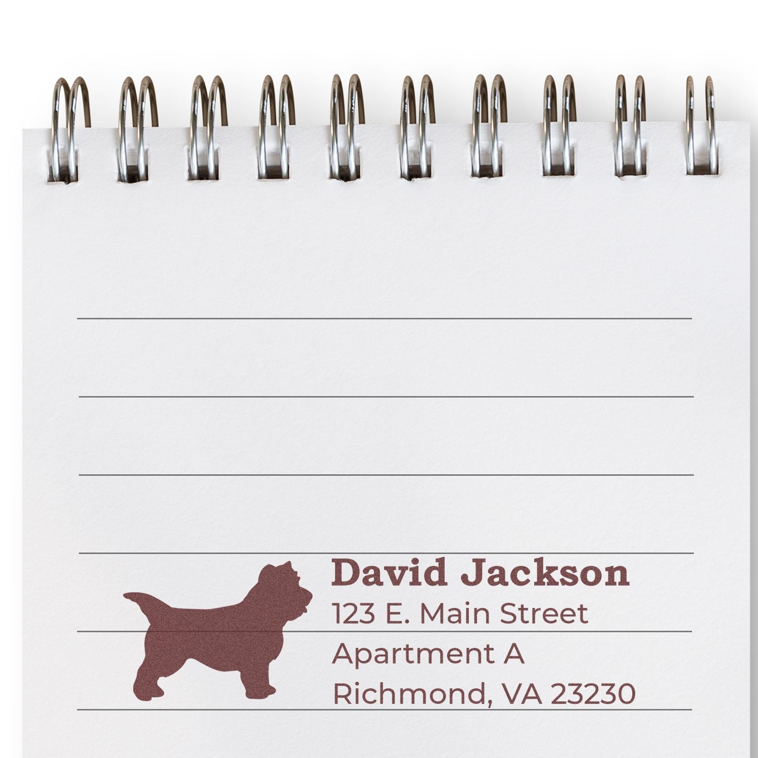 Cairn Terrier Silhouette Address Rubber Stamp on a notepad, featuring a terrier silhouette and sample address text in brown ink. Ideal for personalizing mail with a pet-themed touch.