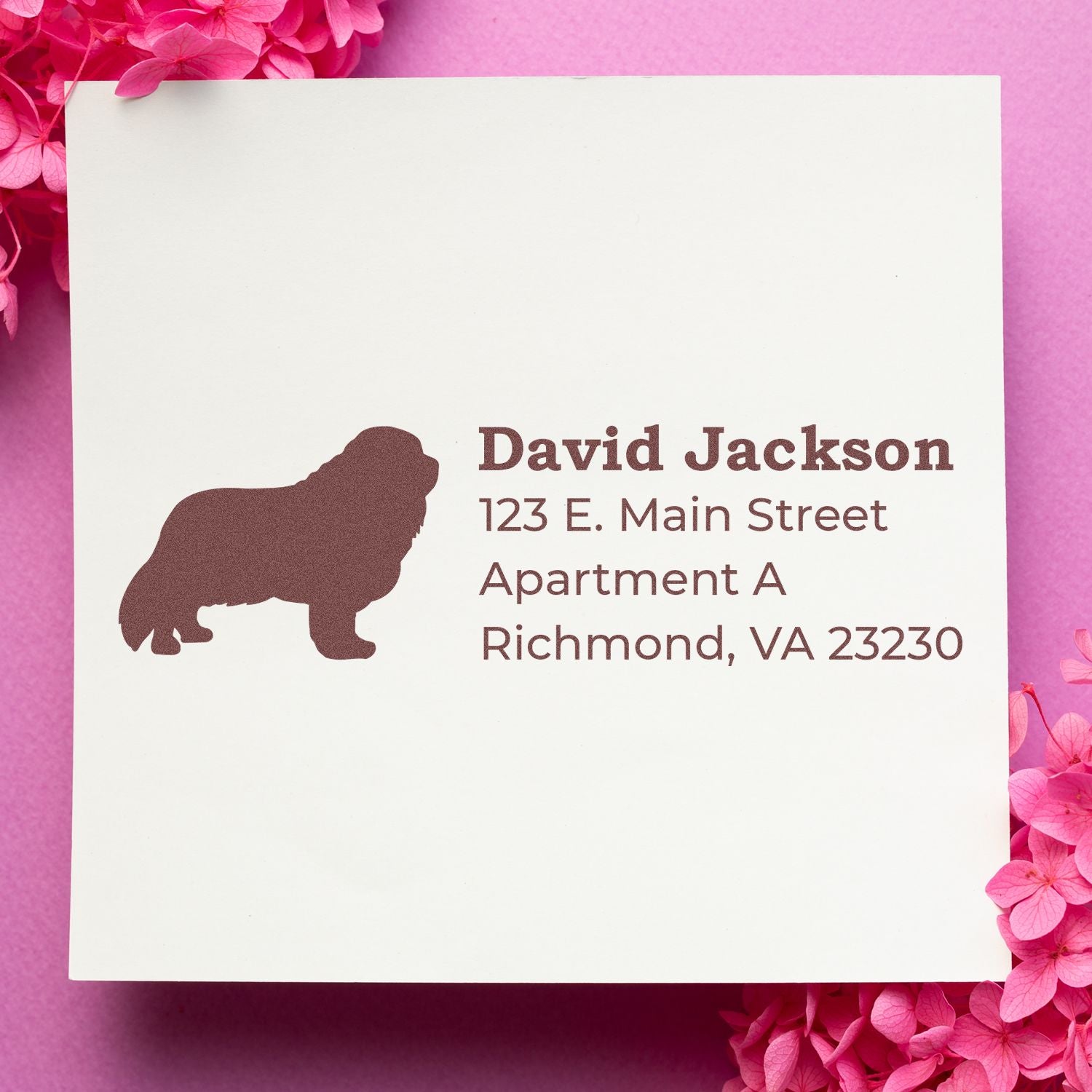 Slim Pre-Inked Cavalier King Charles Address Stamp on white paper with a dog silhouette, surrounded by pink flowers. Text reads: David Jackson, 123 E. Main Street, Apartment A, Richmond, VA 23230.