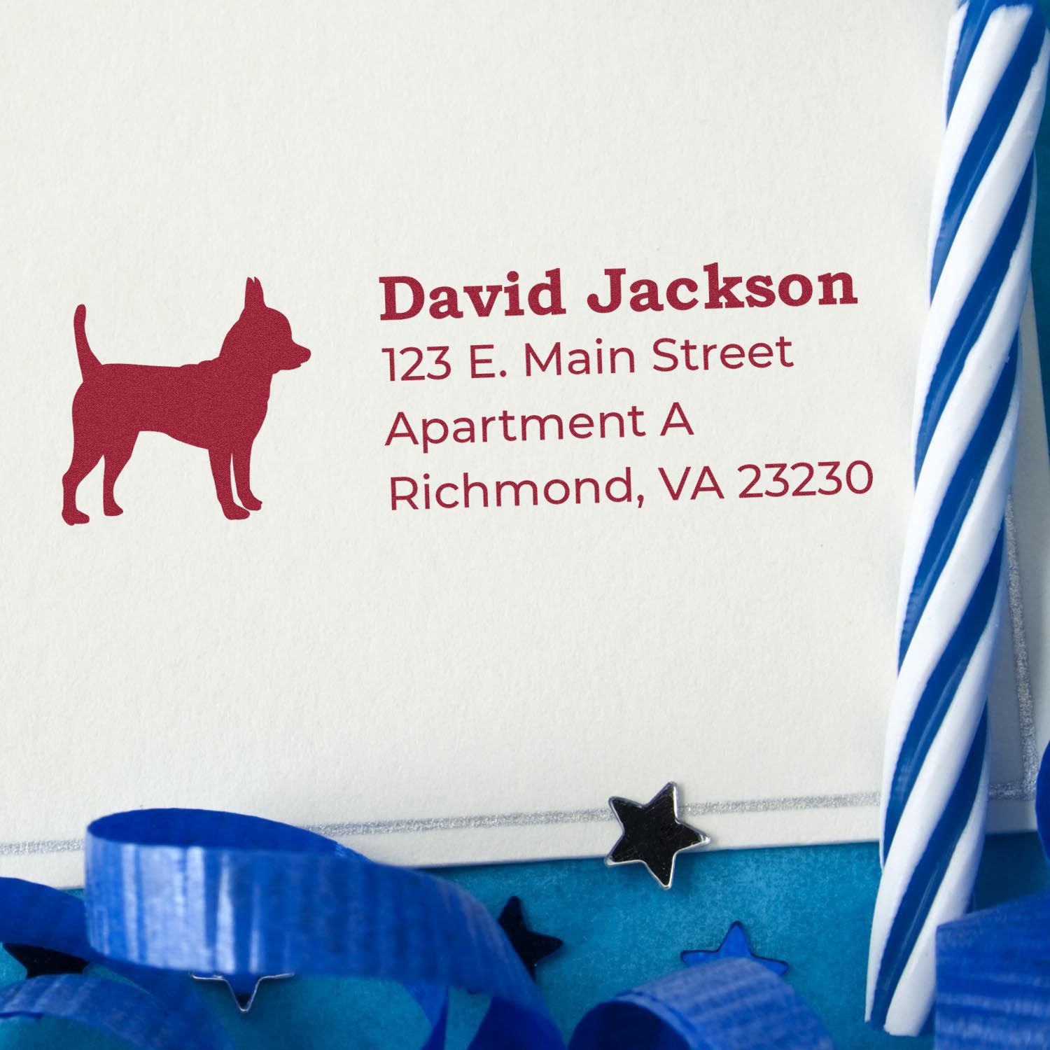 Self-Inking Chihuahua Dog Address Stamp on an envelope with a red Chihuahua silhouette and sample address. Blue ribbon and star decorations are visible. Perfect for personalized mail.