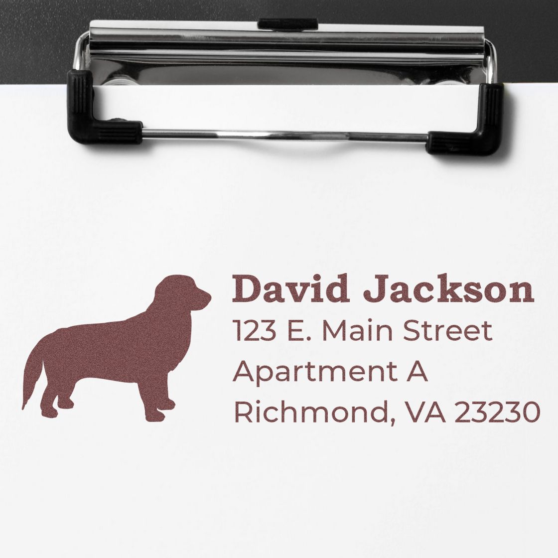 Golden Retriever Silhouette Address Rubber Stamp on paper with text: David Jackson, 123 E. Main Street, Apartment A, Richmond, VA 23230, clipped to a clipboard.