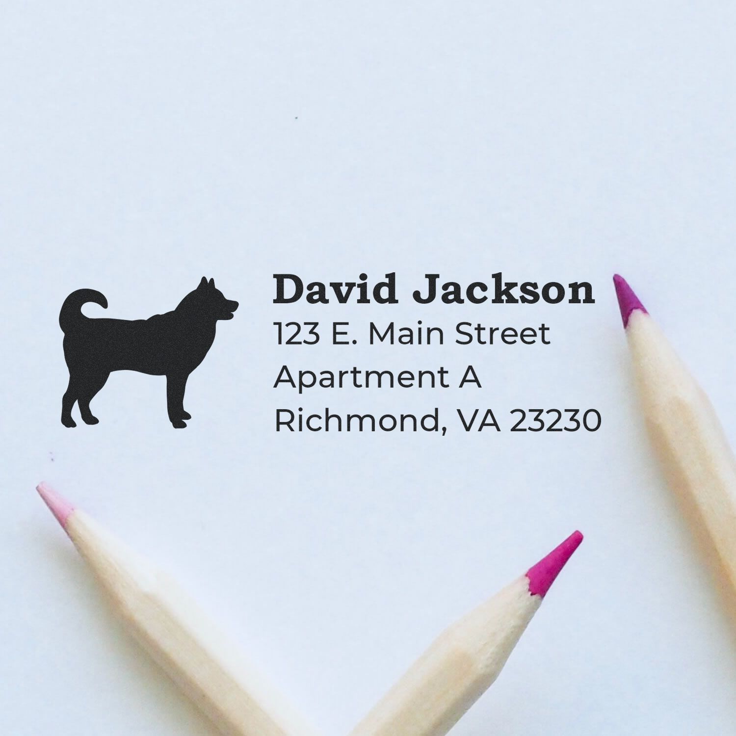 PSI Pre-Inked Personalized Husky Address Stamp on paper with a husky silhouette, next to two pencils with pink tips.