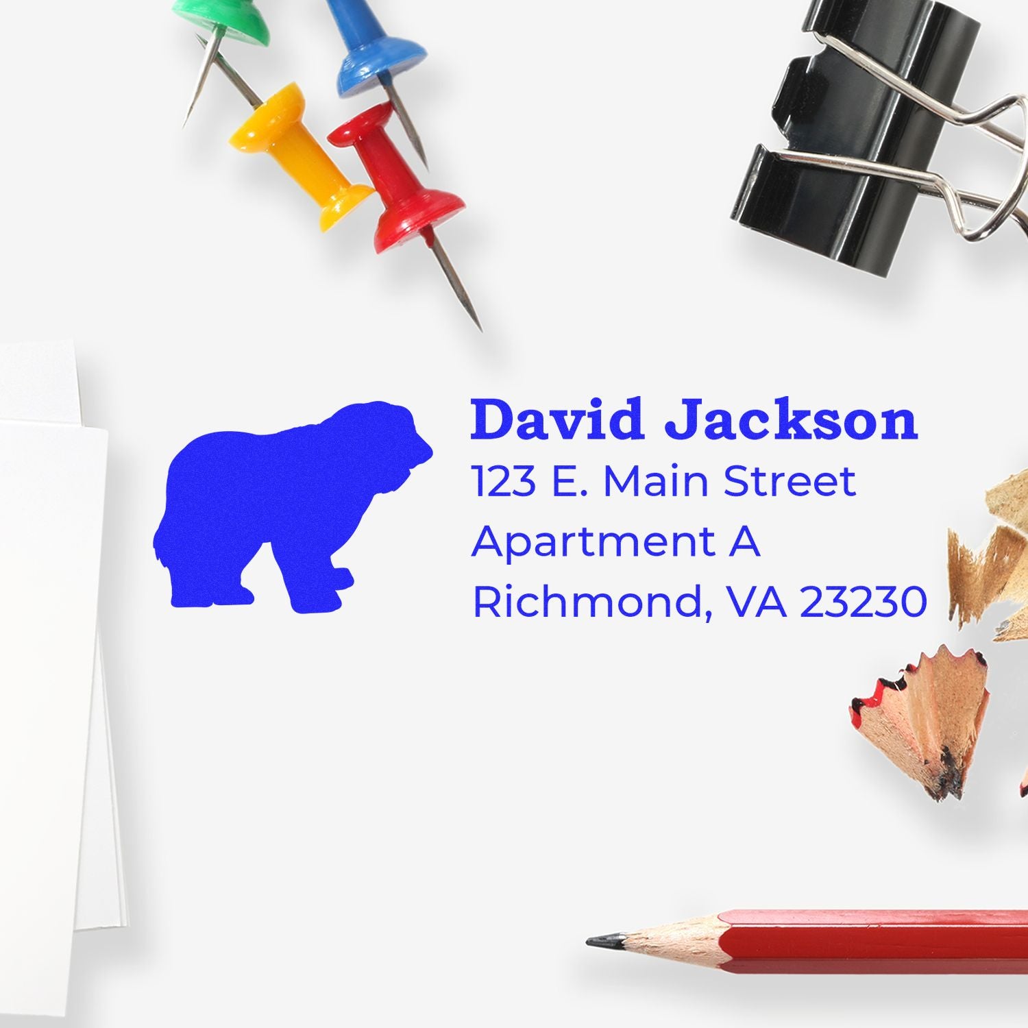 Old English Sheepdog Silhouette Address Rubber Stamp on an envelope with colorful push pins, a binder clip, pencil shavings, and a red pencil. Address reads: David Jackson, 123 E. Main Street, Richmond, VA.