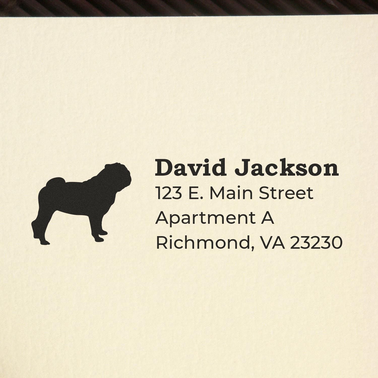 Self-Inking Pug Dog Address Stamp on paper, featuring a pug silhouette and sample address text: David Jackson, 123 E. Main Street, Apartment A, Richmond, VA 23230.