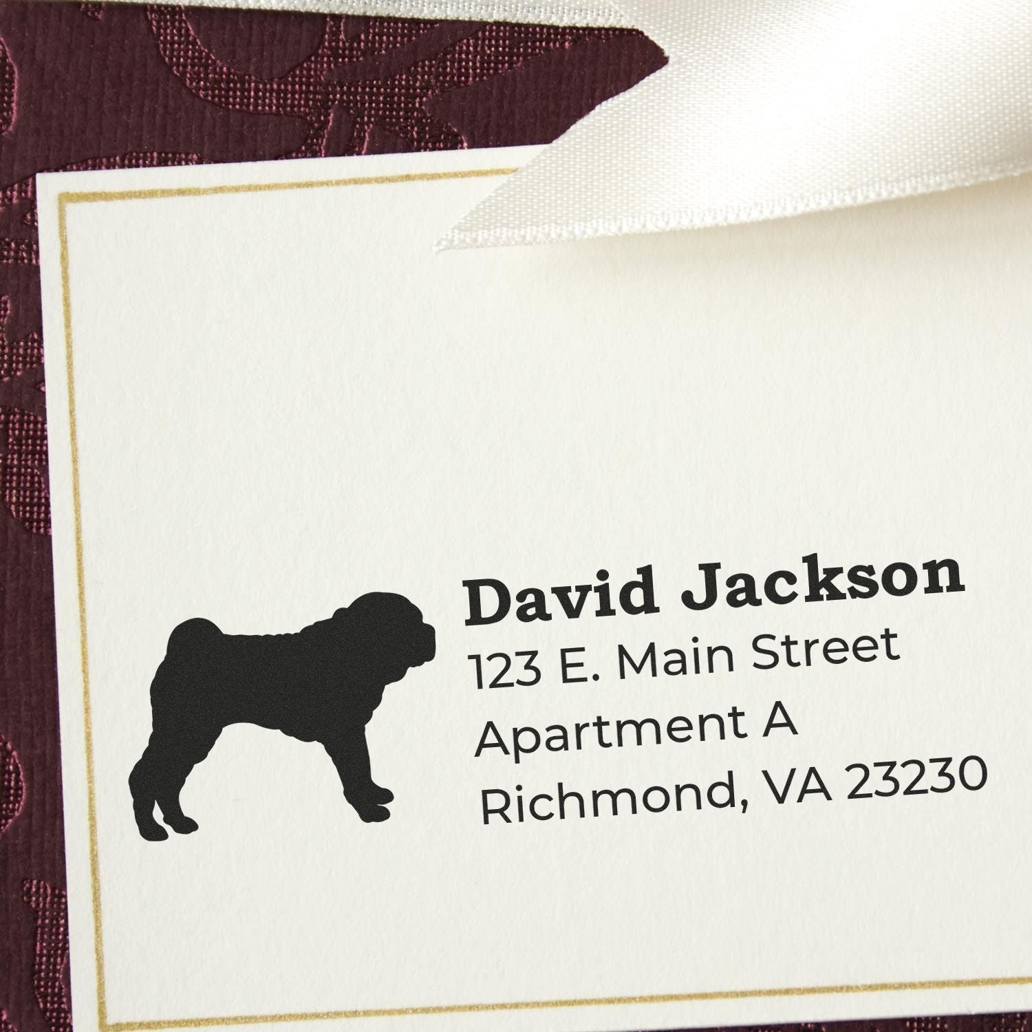 Self-Inking Shar Pei Dog Address Stamp on a white card with a silhouette of a Shar Pei. Text reads David Jackson, 123 E. Main Street, Apartment A, Richmond, VA 23230 on a textured background.