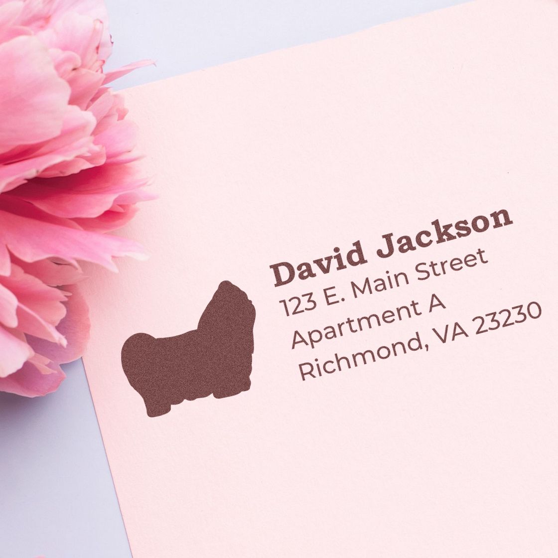 Self-Inking Shih Tzu Dog Address Stamp on pink paper with a floral accent. Displays name, address, and a Shih Tzu silhouette, ideal for personalized stationery.