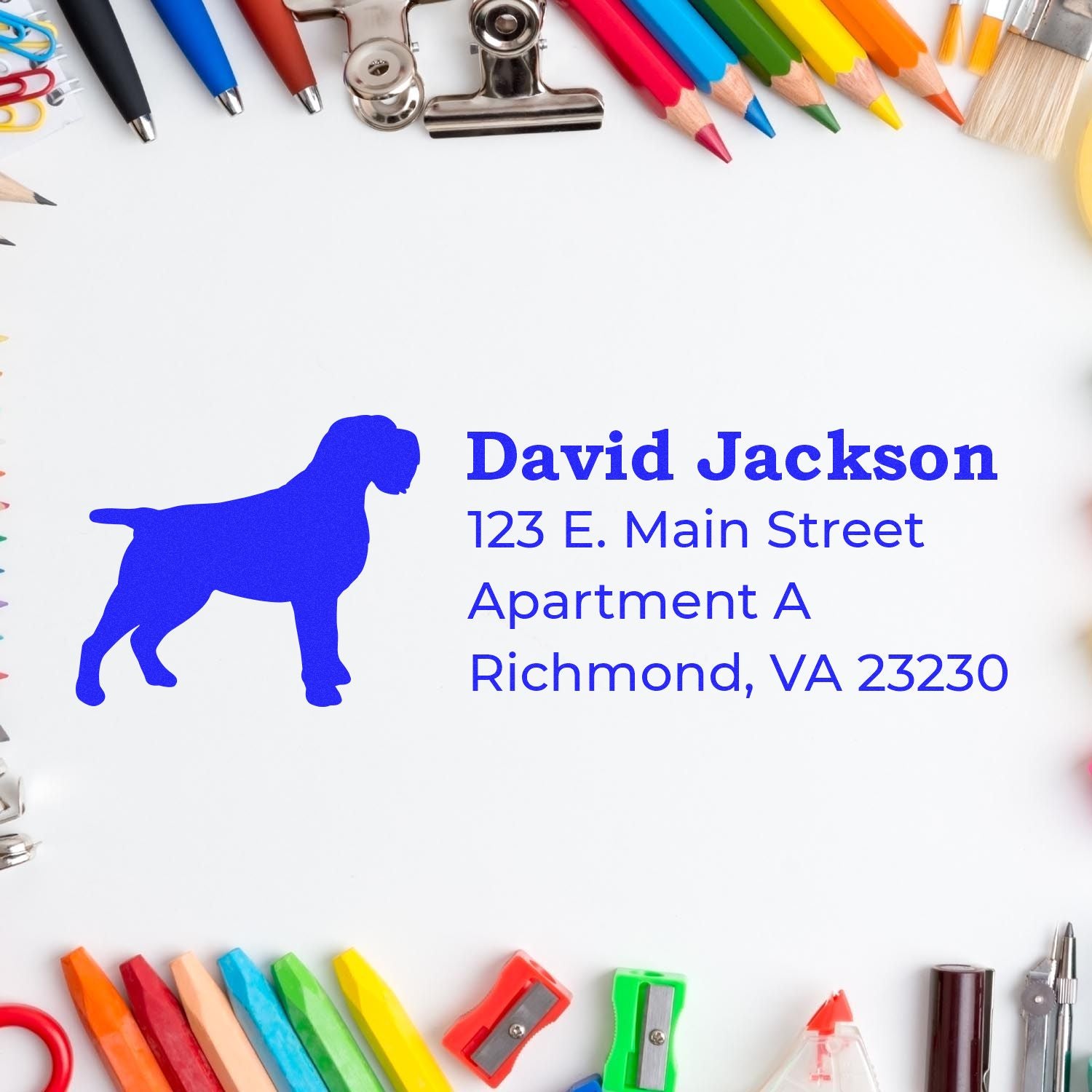 PSI Pre-Inked Personalized Wirehaired Pointing Griffon Address Stamp on paper, surrounded by colorful stationery, featuring a blue dog silhouette and sample address text.