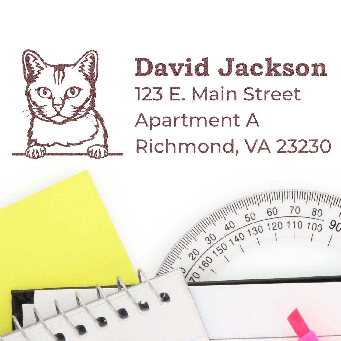 Self-Inking Burmilla Custom Address Stamp featuring a cat design, shown on a white envelope. Nearby are a notebook, ruler, and colorful sticky notes, creating a tidy workspace setting.