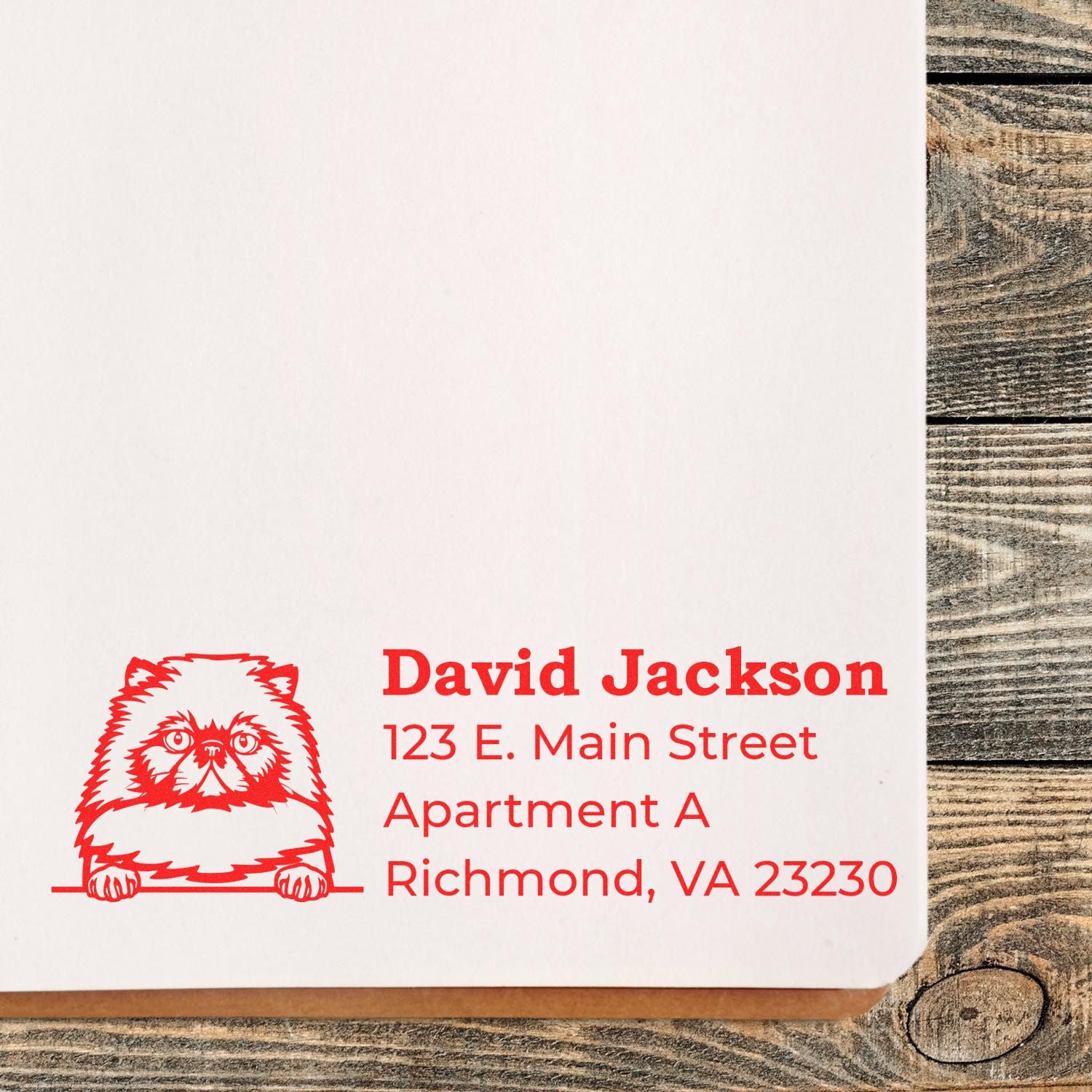 Wood Handle Himalayan Cat Address Stamp on paper, featuring a red cat illustration and sample address text. The stamp is placed on a wooden surface, showcasing its elegant design and clear imprint.