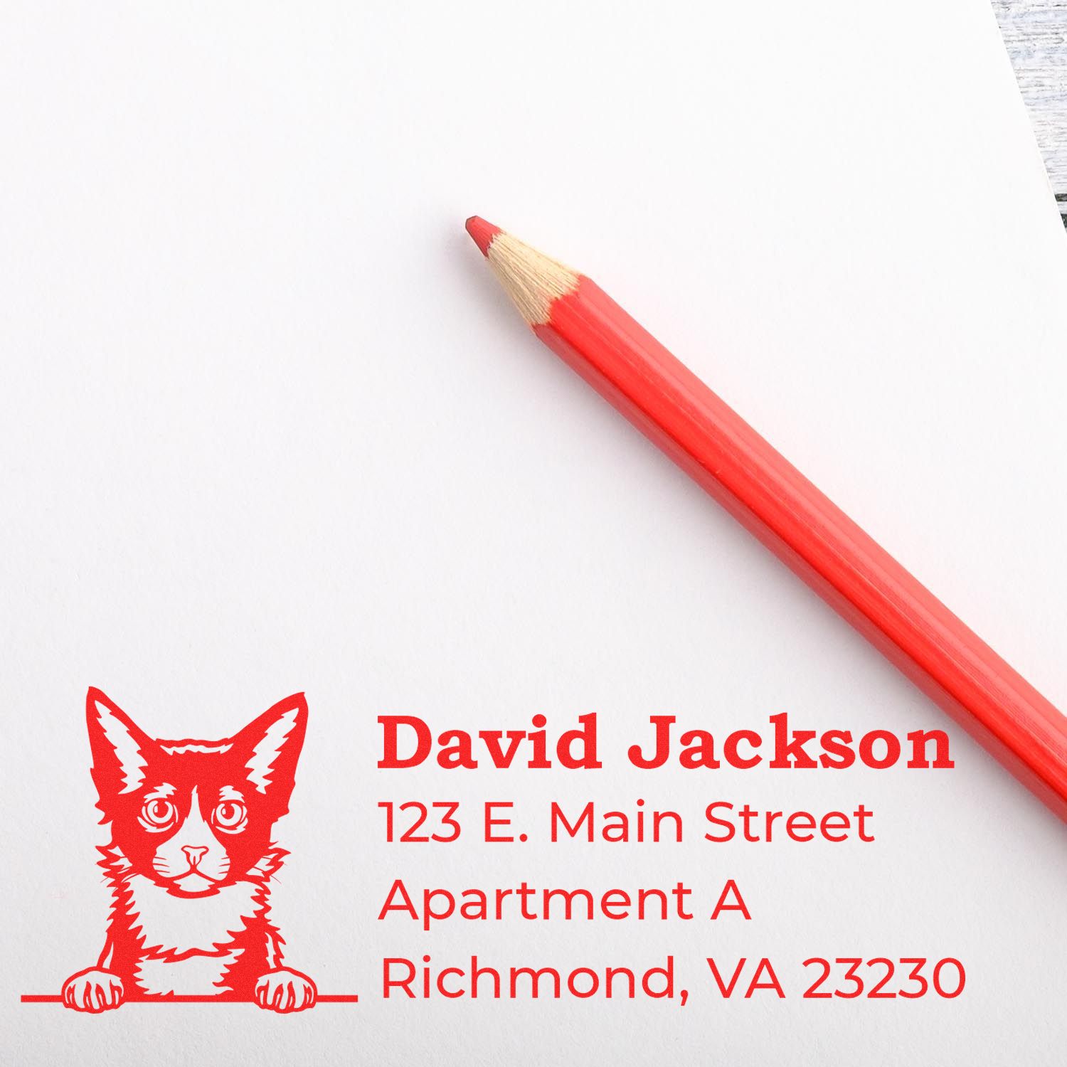 Wood Handle LaPerm Cat Address Stamp on white paper with a red cat illustration and address details. A red pencil lies nearby, complementing the stamp's design.