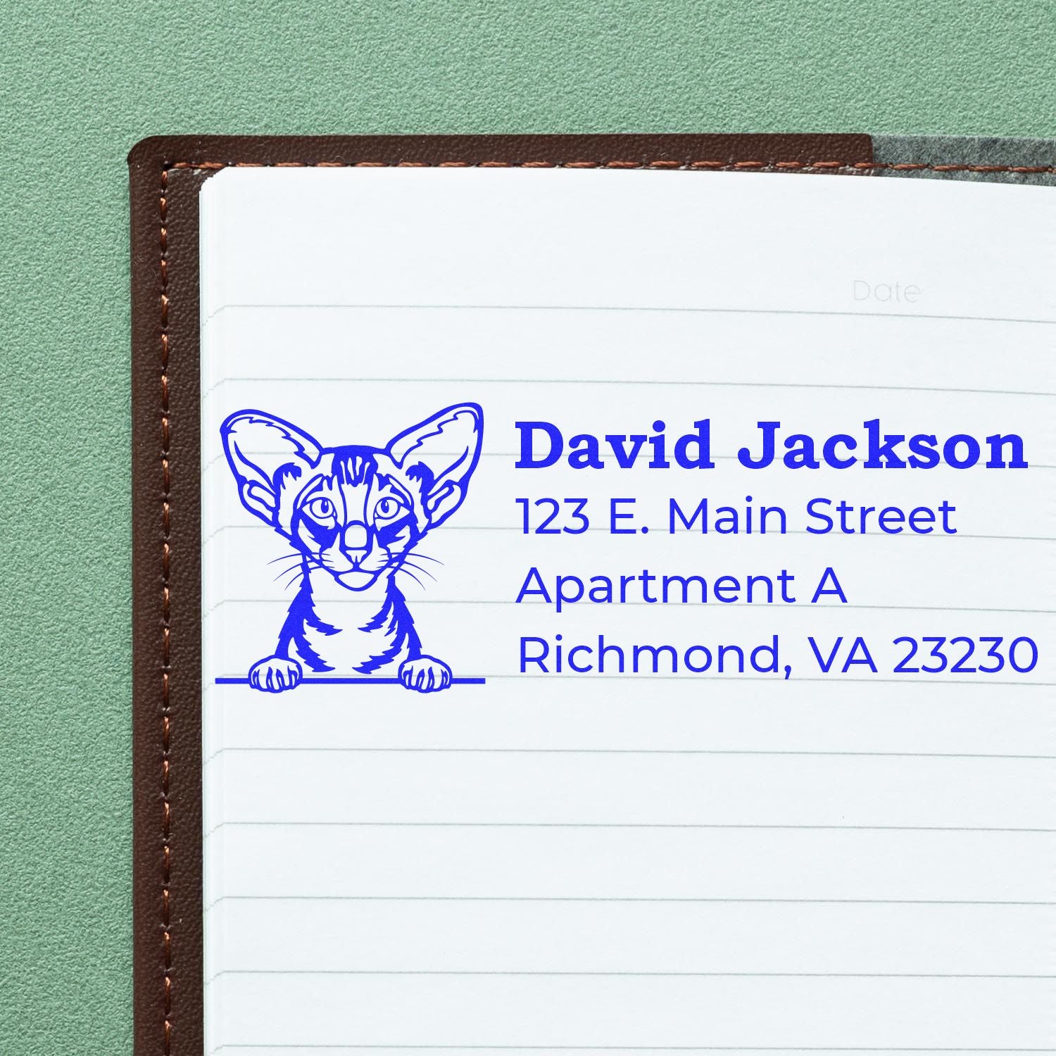 Self-Inking Oriental Shorthair Custom Address Stamp on a notebook page, featuring a blue cat illustration and sample address text.