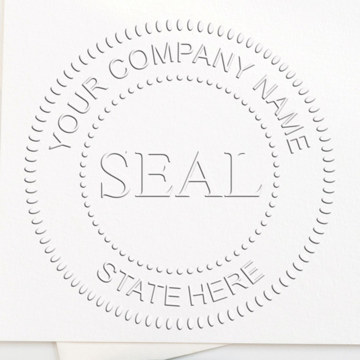 White embossed company seal stamp with dotted border, YOUR COMPANY NAME, SEAL, and STATE HERE text on white paper.