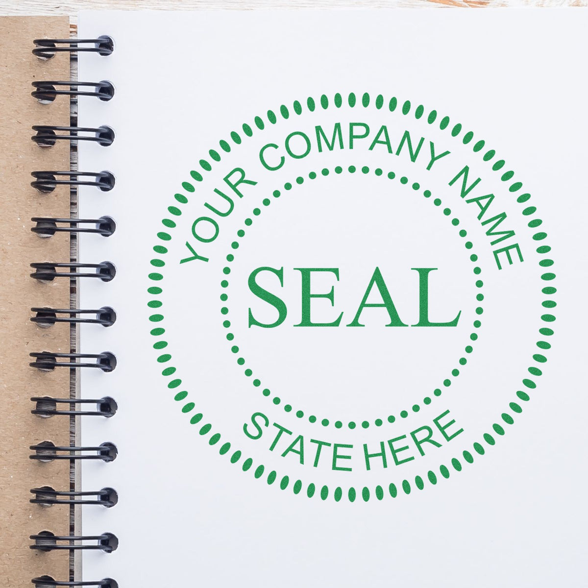 Green company seal stamp on white spiral notebook page with dotted circle and placeholder text, Your Company Name and State Here.