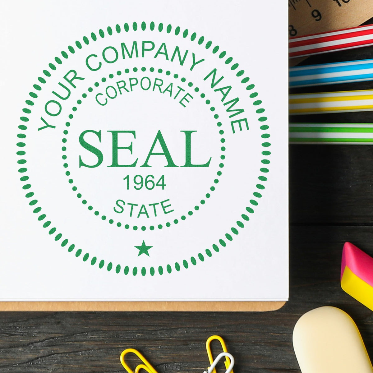 Green corporate seal stamp with dotted border, Your Company Name, and colorful ink pads on a dark desk.