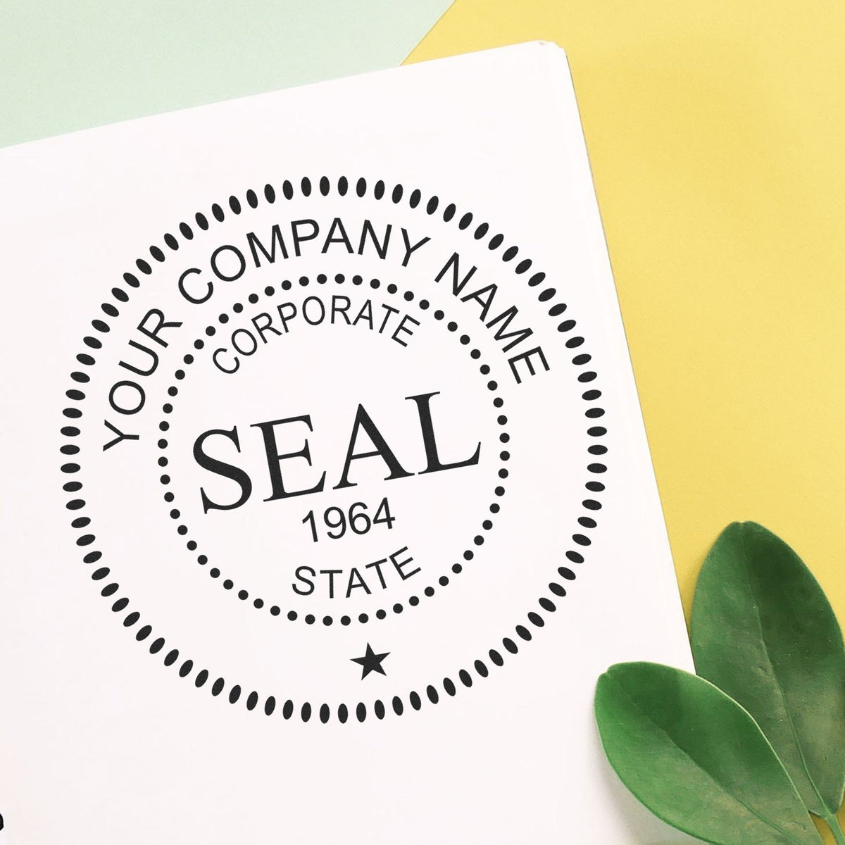 Custom black corporate seal stamp design on white paper, with dotted circle, yellow background, and green leaves.
