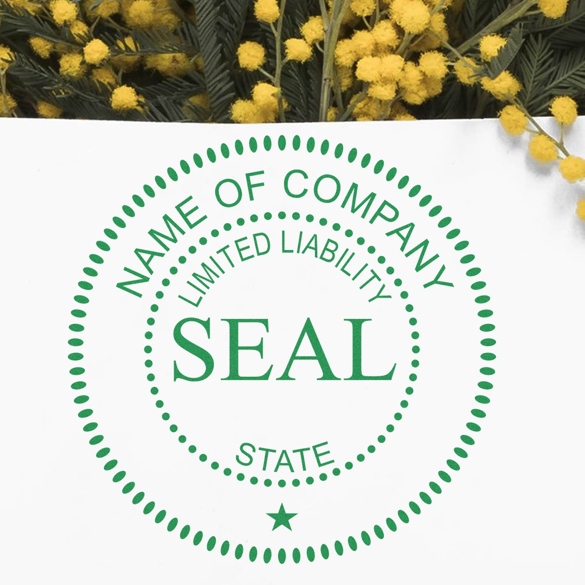 Green company seal stamp with dotted oval border, limited liability text, on white card with yellow flowers.