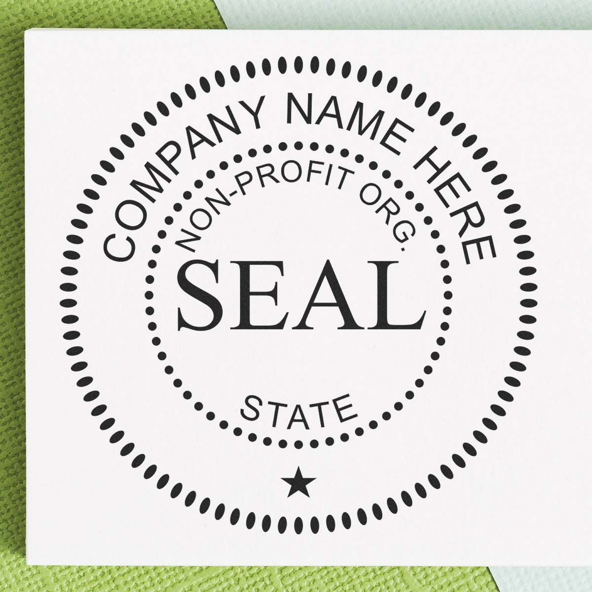 Black custom company seal stamp with dotted oval border, COMPANY NAME HERE, NON-PROFIT ORG., and STATE on white paper.