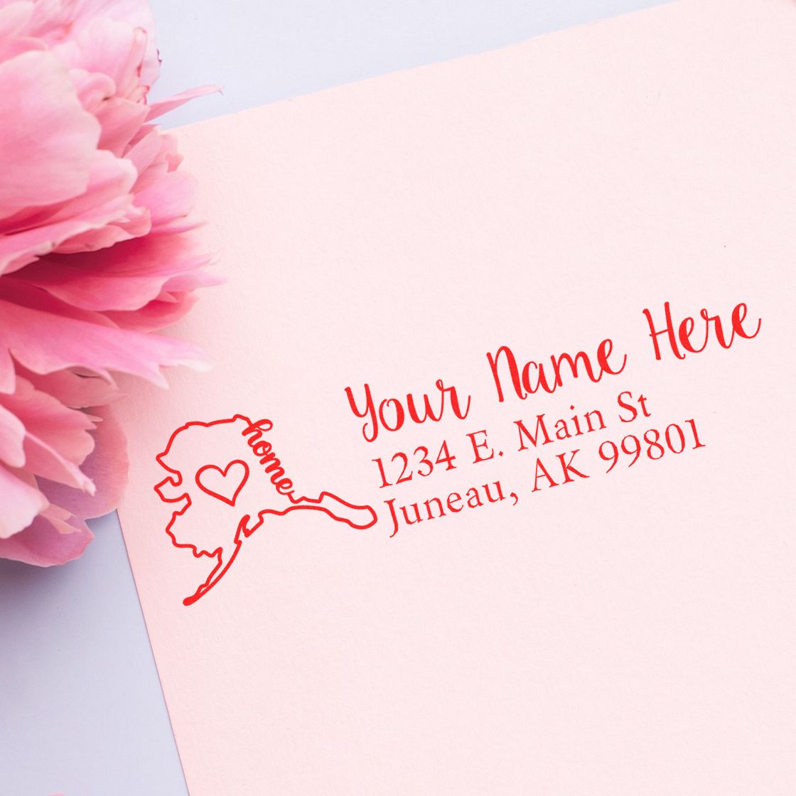 Wood Handle Alaska Custom Address Rubber Stamp on pink paper with a floral accent, featuring a heart design and sample address in red ink.