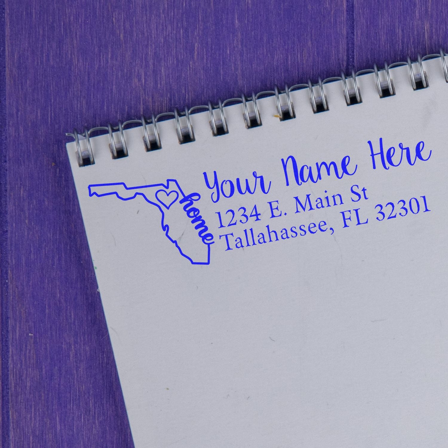 PSI Pre-Inked Personalized Florida State Love Address Stamp on a notepad, featuring a blue outline of Florida with home text and a heart, alongside customizable address details.