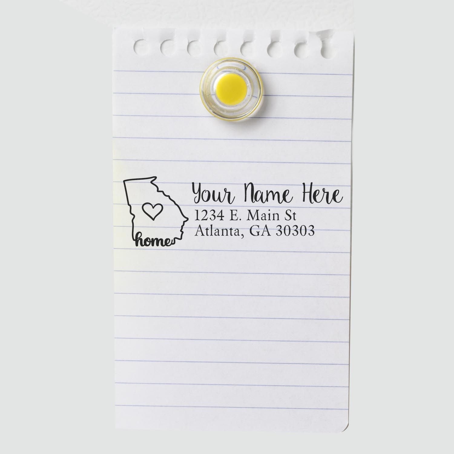 Georgia Self-Inking State Love Address Stamp on notepad, featuring a heart within Georgia's outline and customizable address text. Perfect for personalizing mail with a touch of home.