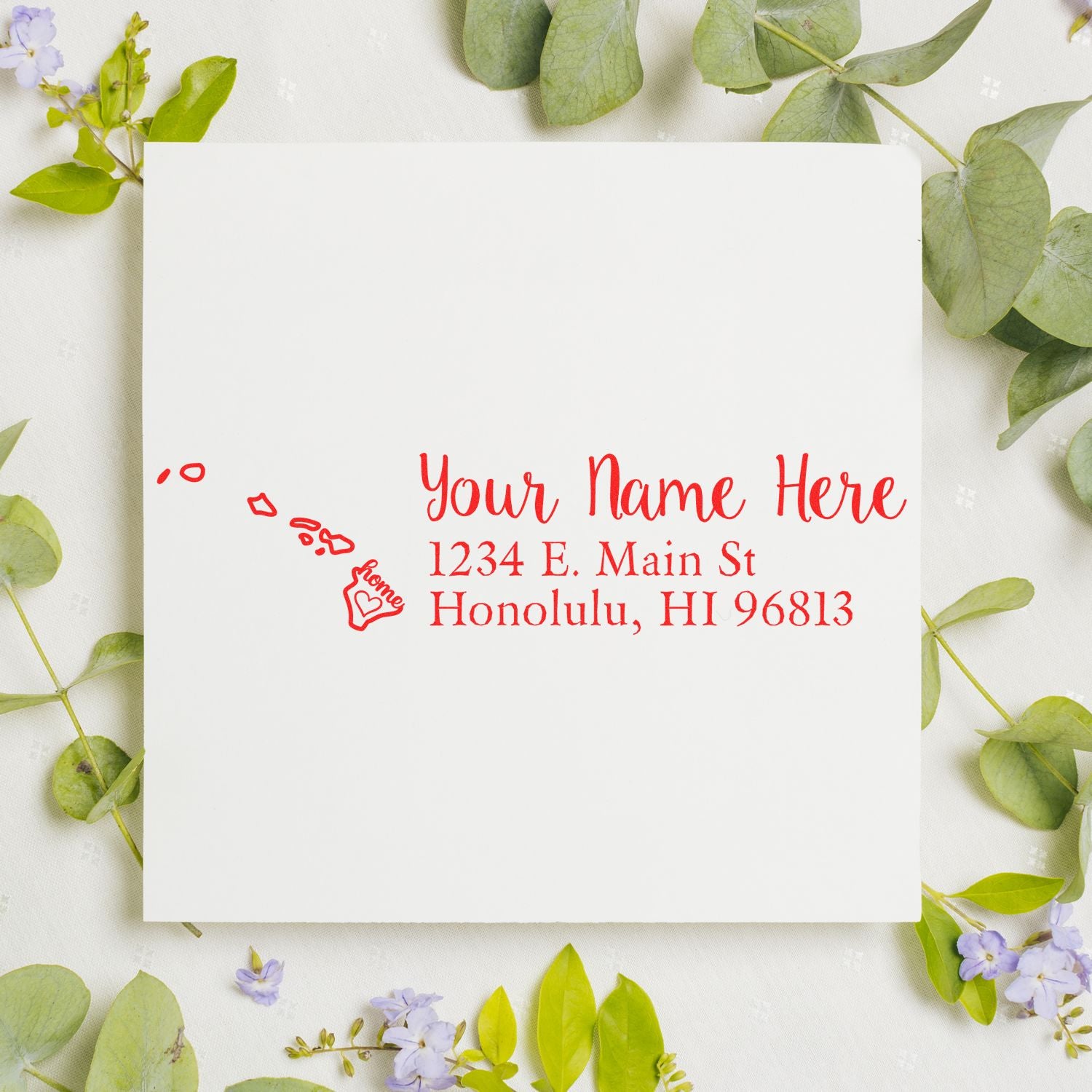 PSI Pre-Inked Personalized Hawaii State Love Address Stamp on white paper, surrounded by green leaves and purple flowers, featuring a red design with a heart and Hawaii map.