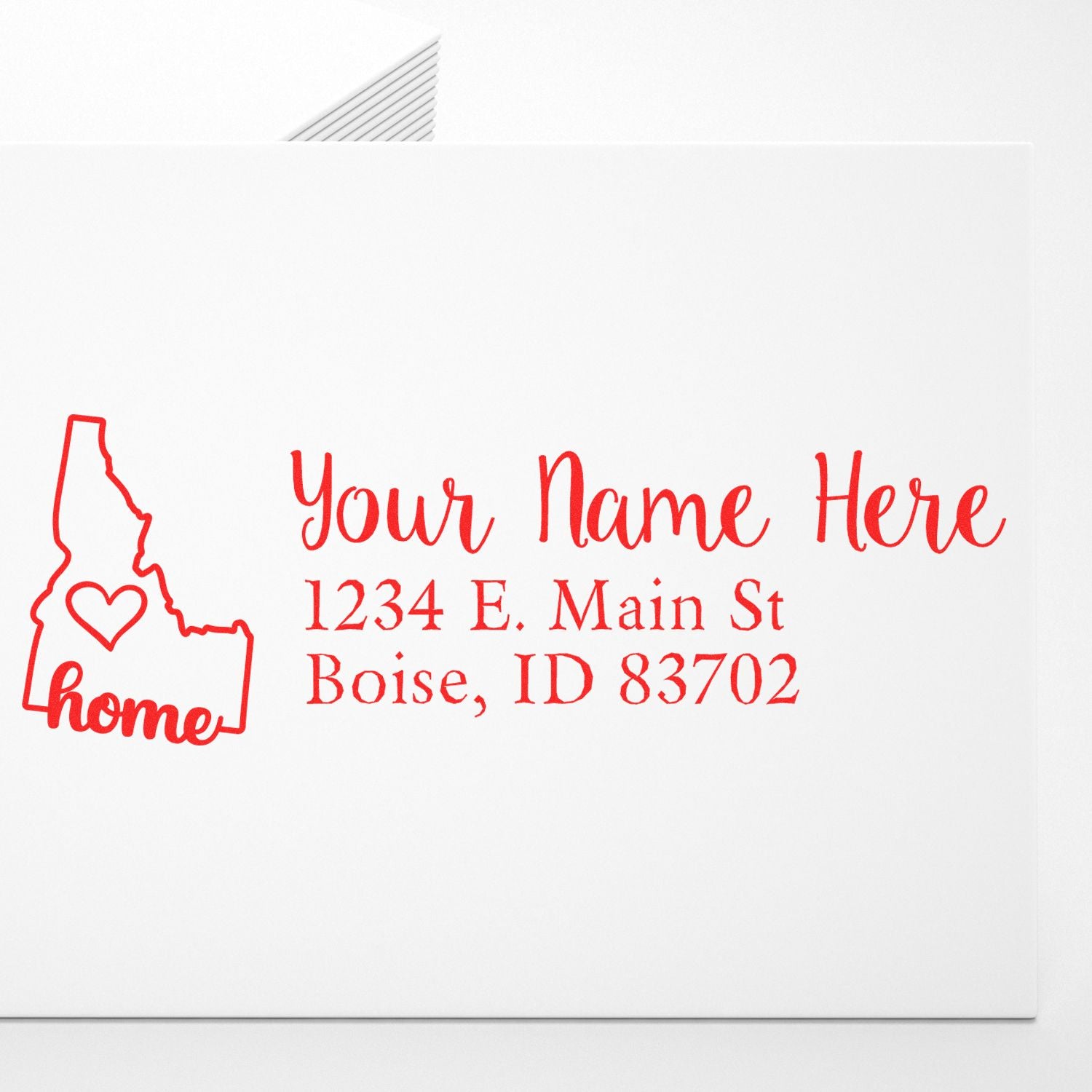 Wood Handle Idaho Custom Address Rubber Stamp imprint on white paper, featuring a red outline of Idaho with home text and customizable address in elegant red script.