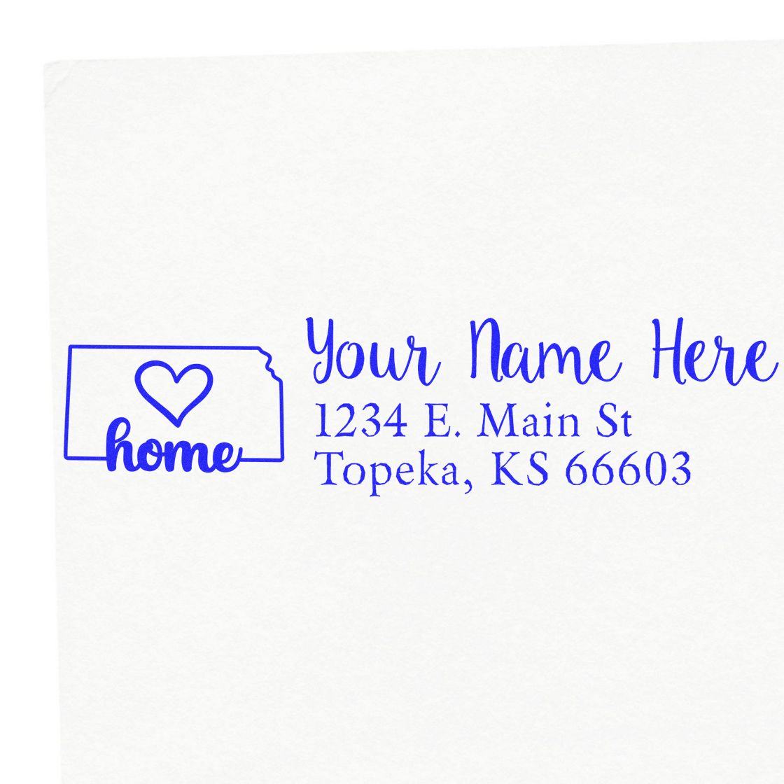 Wood Handle Kansas Custom Address Rubber Stamp imprint on white paper, featuring a heart design and sample address: 1234 E. Main St, Topeka, KS 66603, in blue ink.