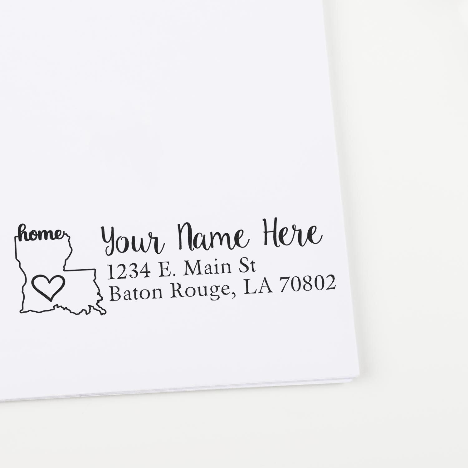 Louisiana Self-Inking State Love Address Stamp on white paper, featuring a heart inside the state outline and customizable text for name and address in Baton Rouge, LA.