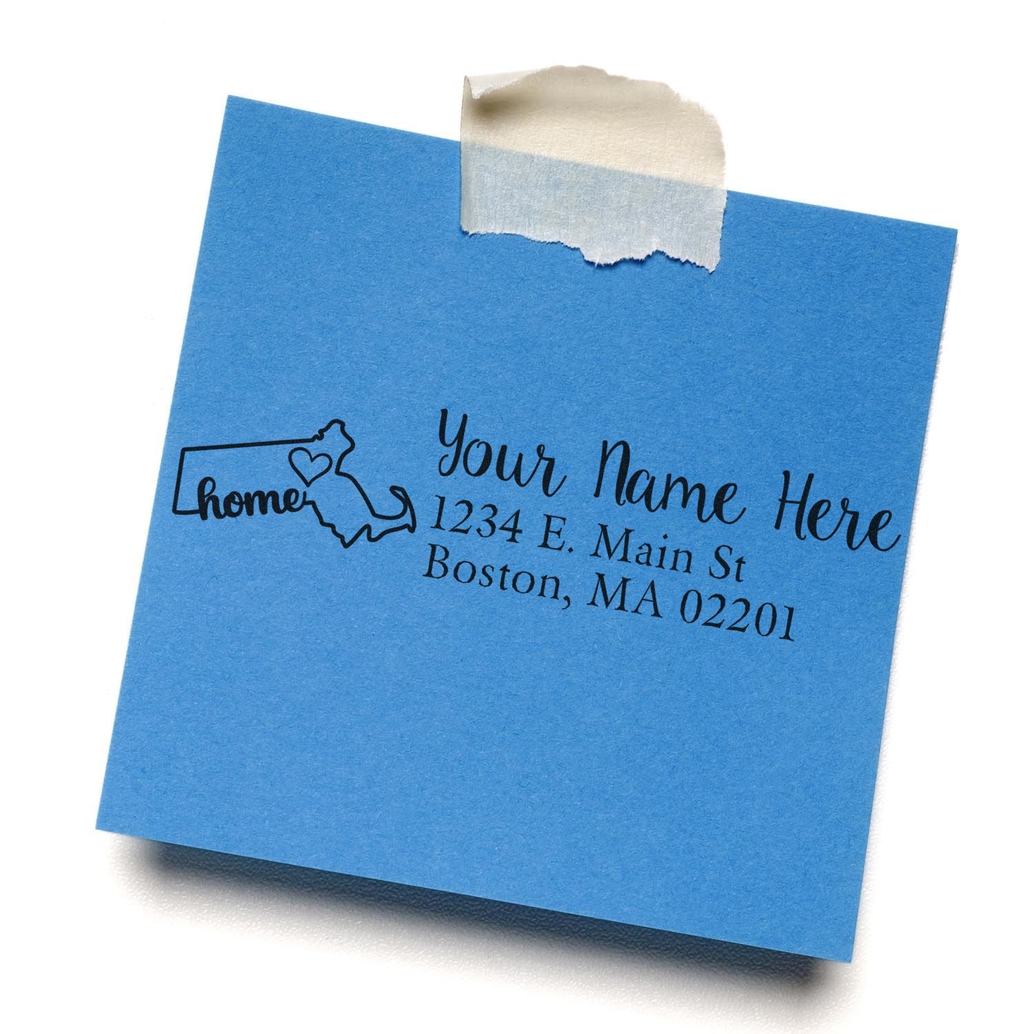 Blue sticky note with a stamped address design featuring the outline of Massachusetts and the word home with a heart. The Wood Handle Massachusetts Custom Address Rubber Stamp is used for personalization.