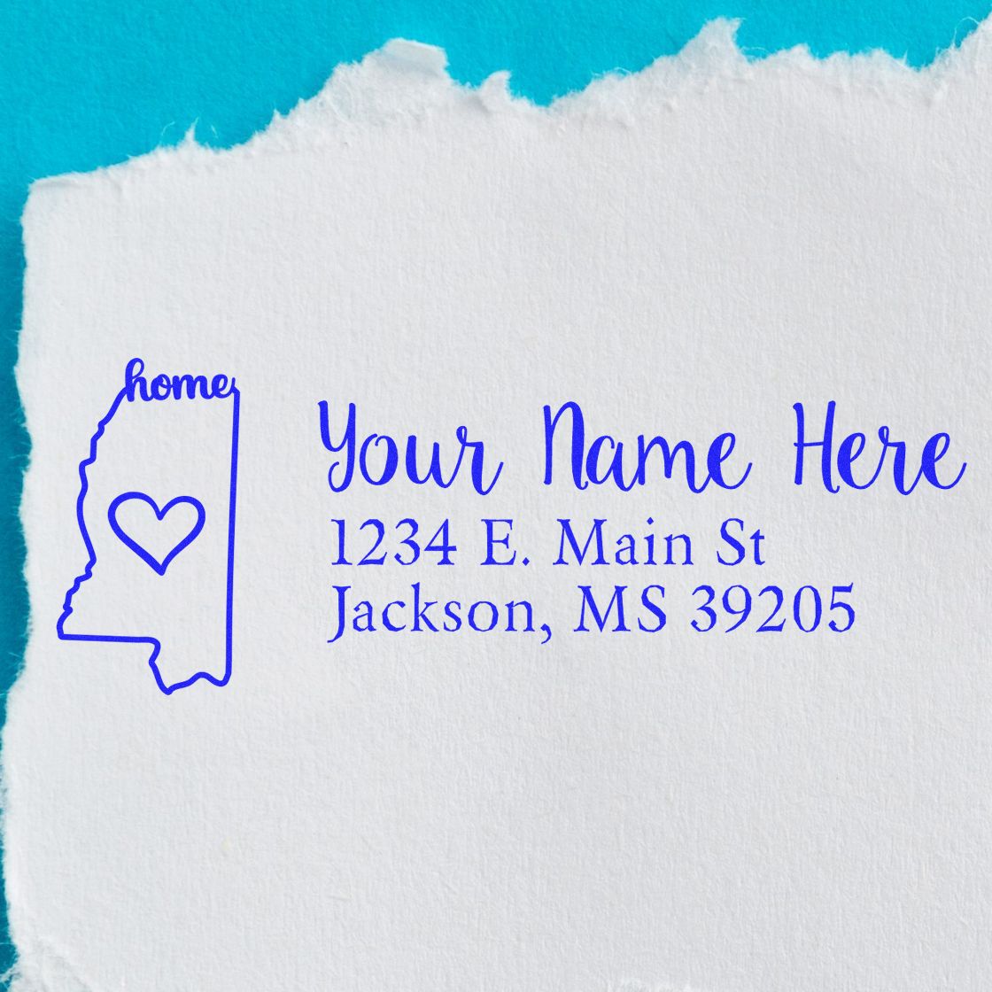 Slim Pre-Inked Mississippi State Love Custom Address Stamp on white paper with blue ink, featuring a heart inside the state outline and customizable text for name and address.