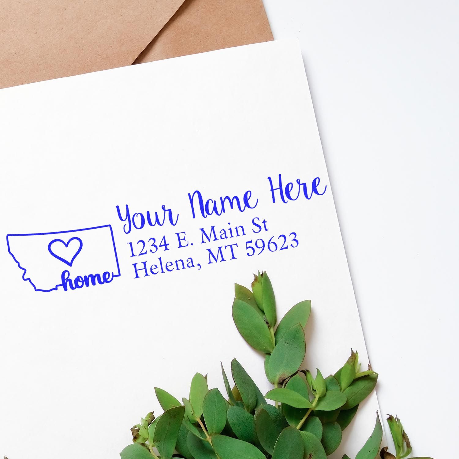 PSI Pre-Inked Personalized Montana State Love Address Stamp on white envelope with green leaves, featuring a heart design and customizable address text.