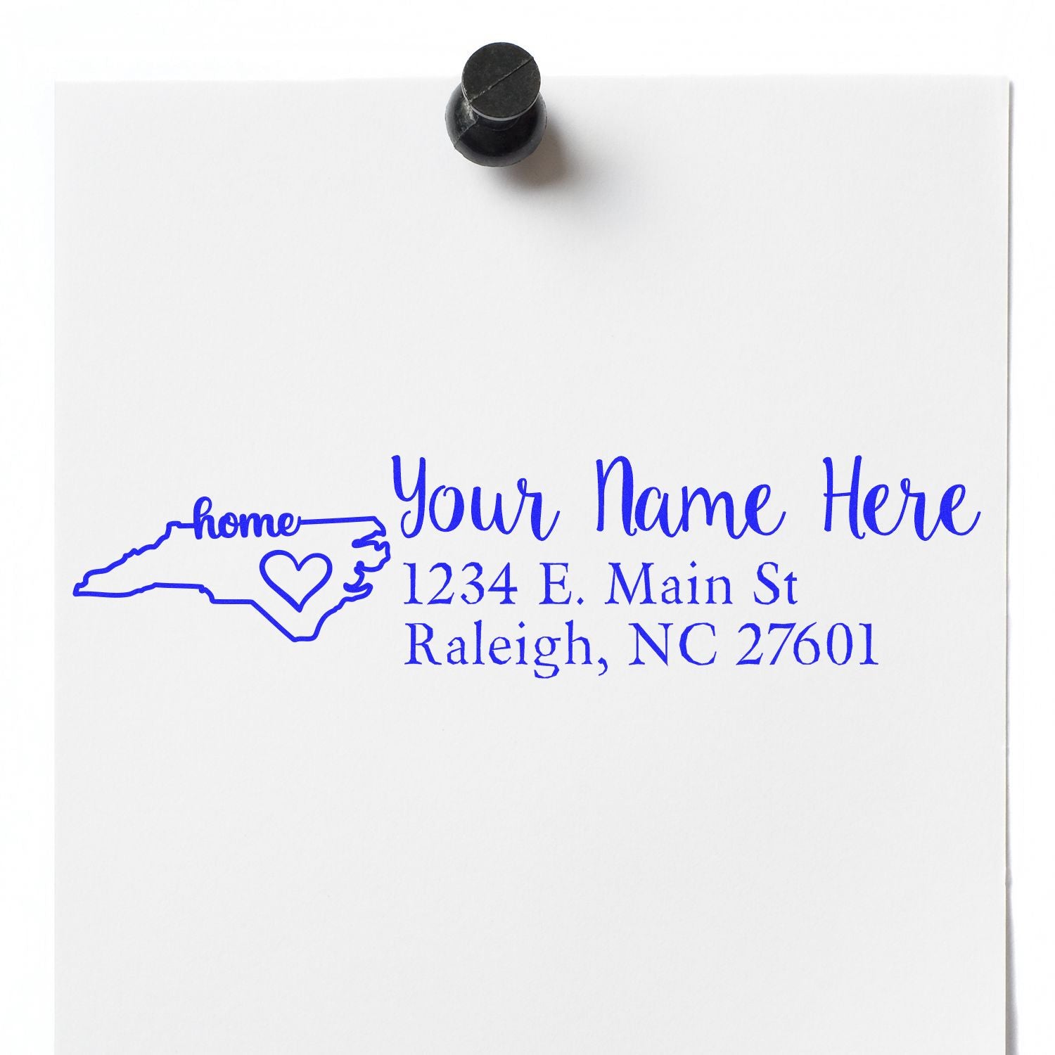 Image of the North Carolina Self-Inking State Love Address Stamp imprint on white paper, featuring a blue outline of North Carolina with a heart and sample address text in elegant font.