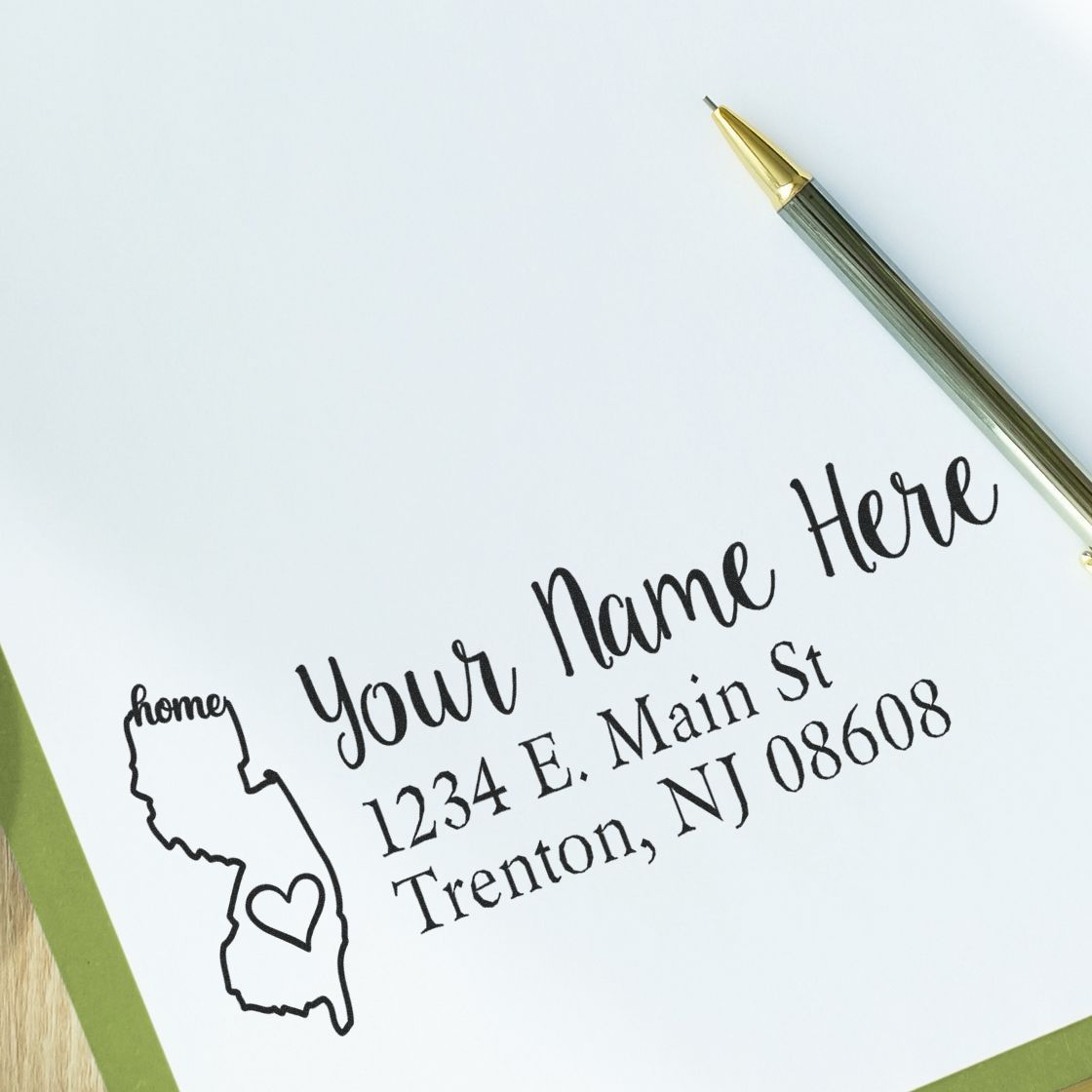 PSI Pre-Inked Personalized New Jersey State Love Address Stamp on white paper, featuring a heart design within the state outline and customizable address text.