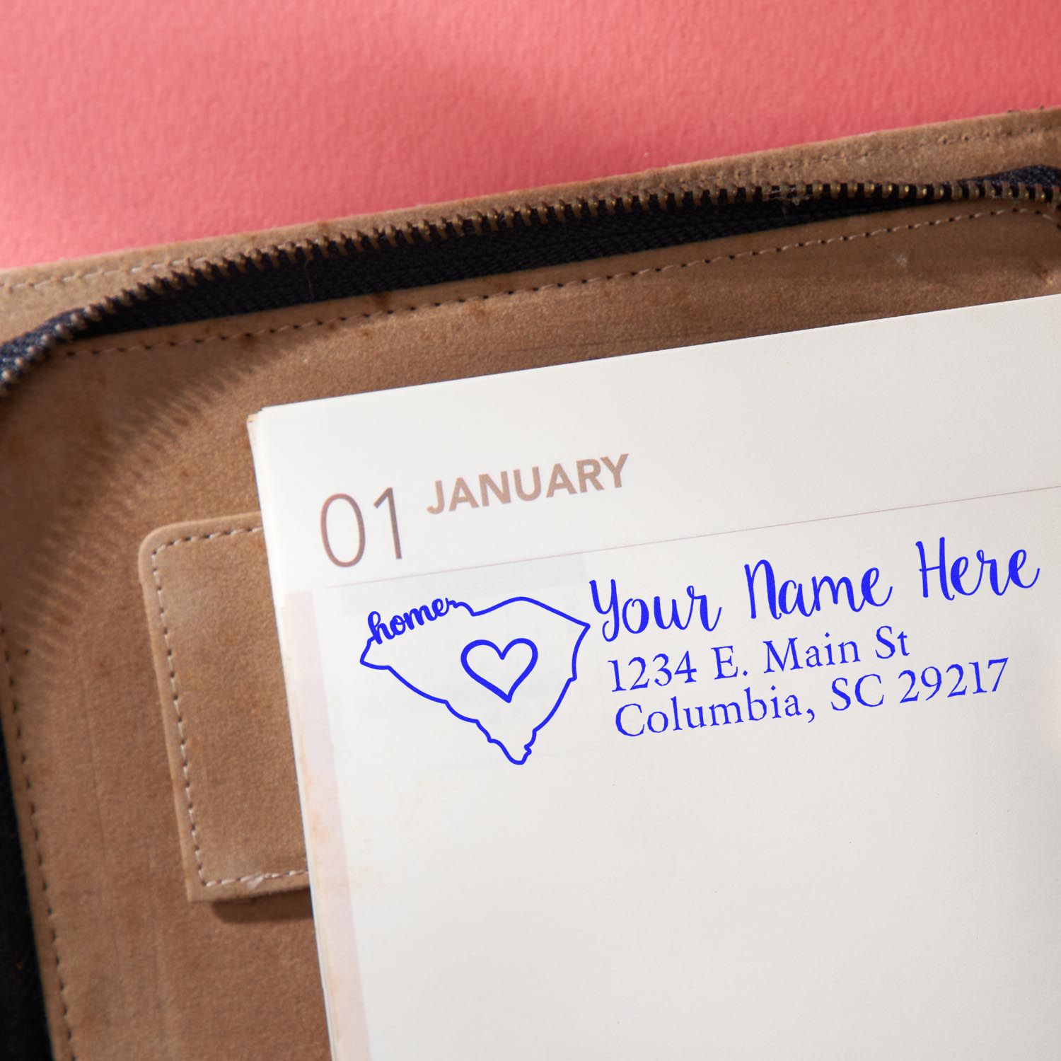 PSI Pre-Inked Personalized South Carolina State Love Address Stamp on a planner page, featuring a heart design within the state outline, with customizable name and address in blue ink.