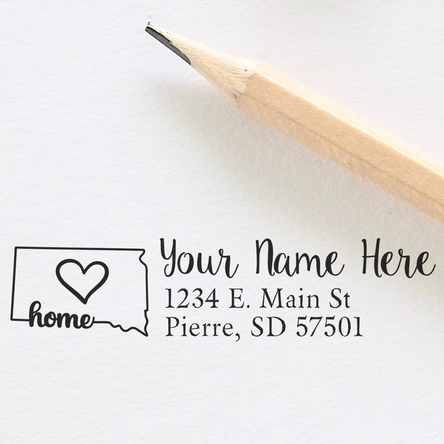 South Dakota Self-Inking State Love Address Stamp with a heart design, featuring customizable name and address. Includes a pencil for scale on a white background.