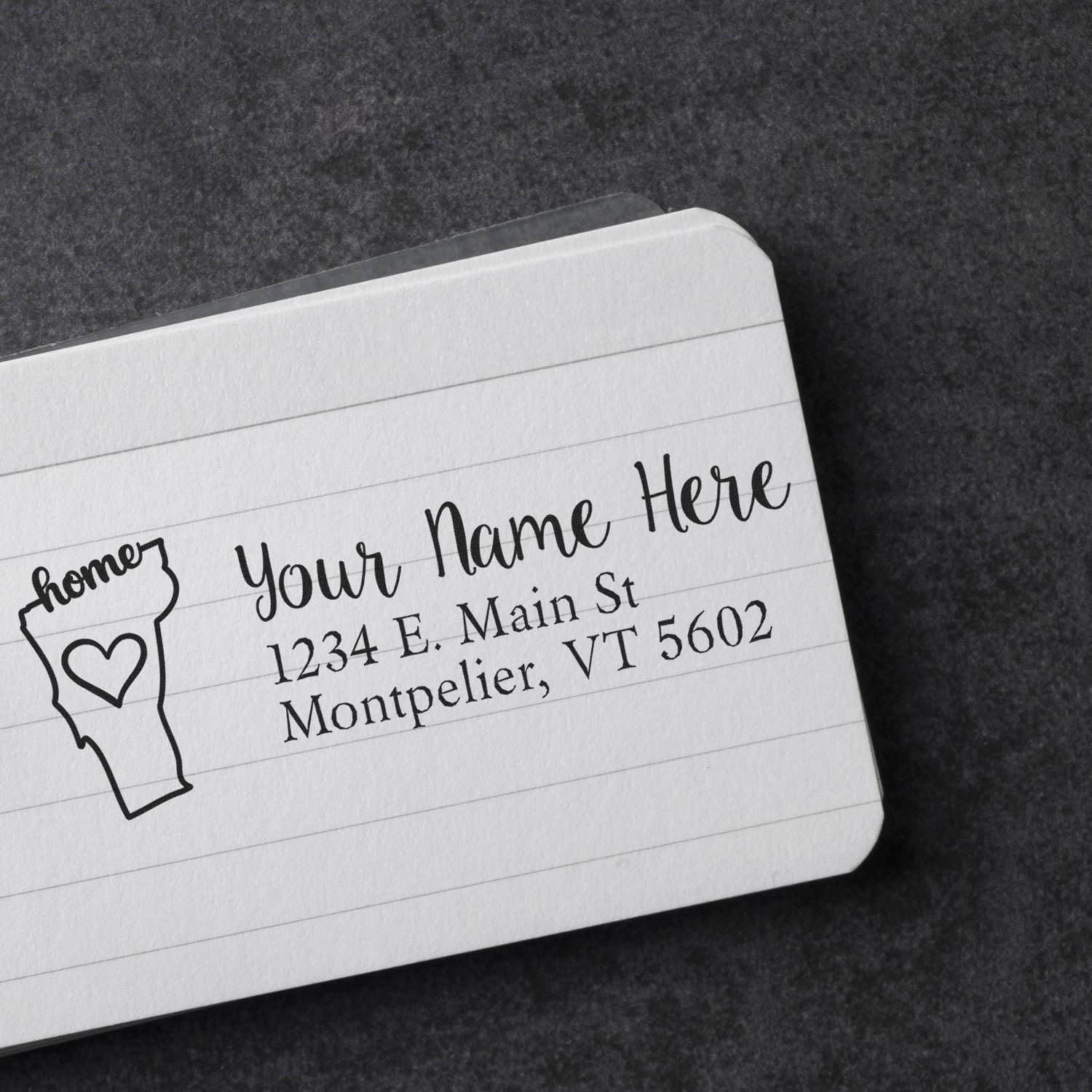 Vermont Self-Inking State Love Address Stamp on a lined card, displaying 'Your Name Here' with a heart in Vermont shape, and an address in Montpelier, VT. Perfect for personalized mail.