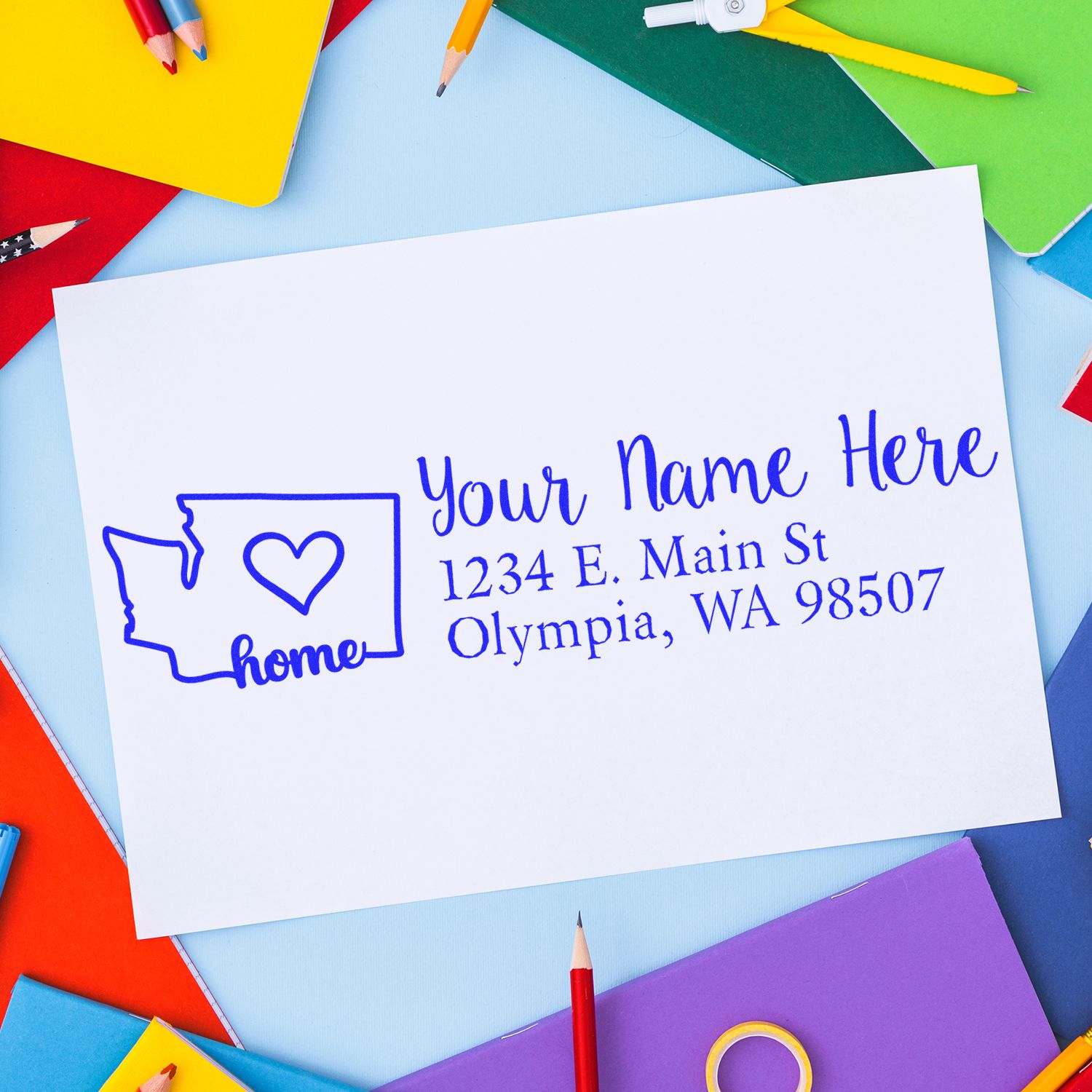 Washington Self-Inking State Love Address Stamp on colorful paper background, featuring a heart in the state outline and sample address text in blue.