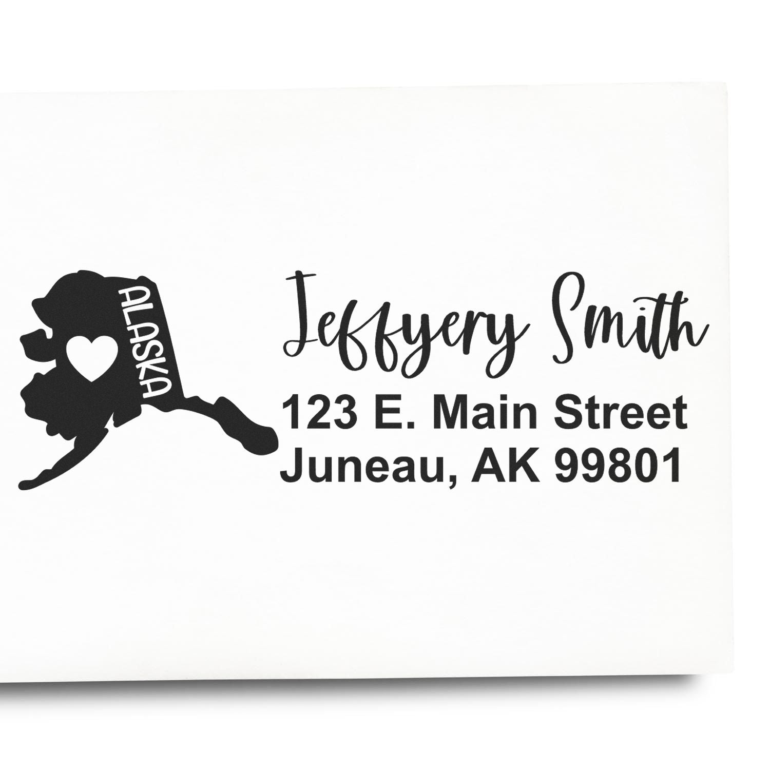 Slim Alaska Custom Address Stamp for Envelopes featuring a heart design on the Alaska map, personalized with Jeffery Smith, 123 E. Main Street, Juneau, AK 99801 in elegant black font.