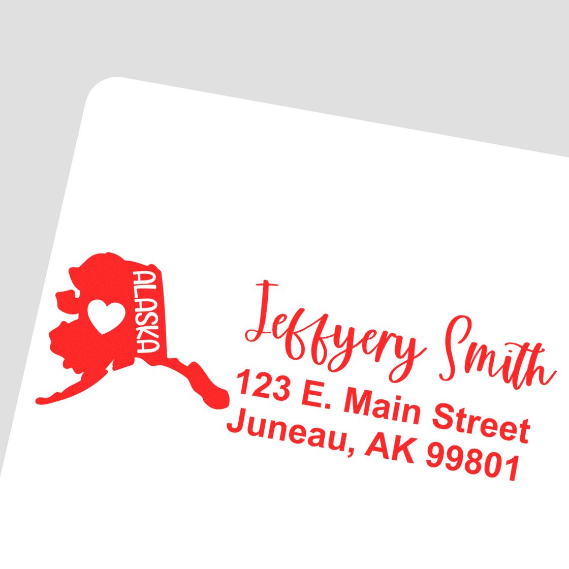 Slim Alaska Custom Address Stamp for Envelopes featuring a red Alaska map with a heart, personalized with Jeffery Smith, 123 E. Main Street, Juneau, AK 99801 in elegant red script.