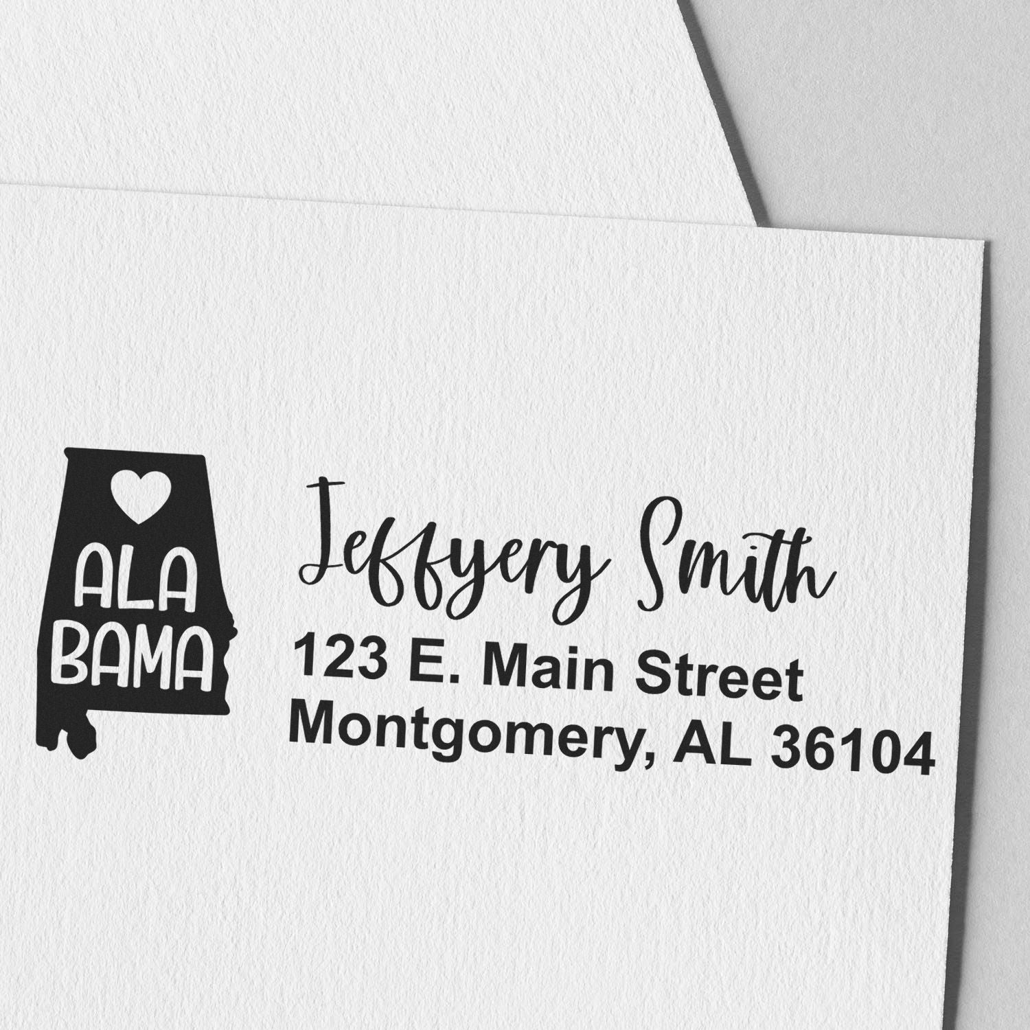 Alabama State Love Personalized Address Stamp on white paper, featuring a heart and Alabama design, with handwritten-style text for name and address.