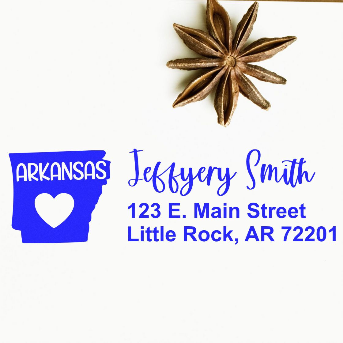 PSI Pre-Inked Arkansas State Love Customized Address Stamp showing 'Arkansas' with a heart, personalized with 'Jeffery Smith, 123 E. Main Street, Little Rock, AR 72201' on white paper.