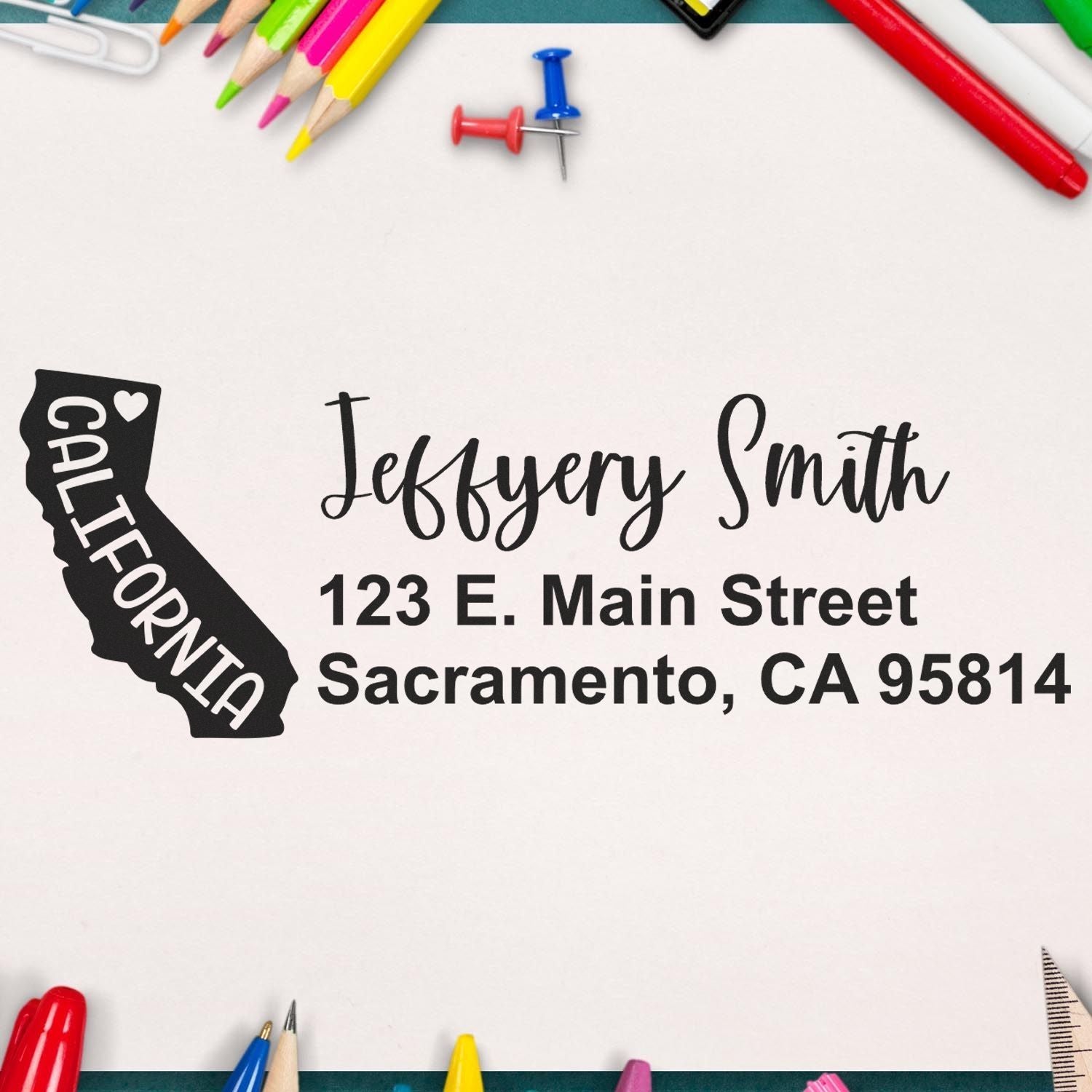 PSI Pre-Inked California State Love Customized Address Stamp on paper with colorful stationery. Features a California state outline and personalized address in elegant font.