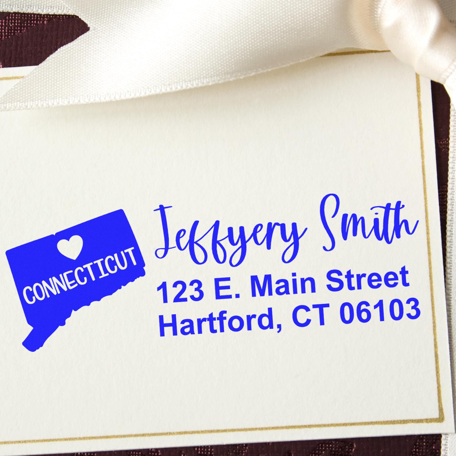 Connecticut State Love Personalized Address Stamp on a card with a ribbon, featuring a heart and state outline, displaying the name Jeffery Smith and address in blue text.