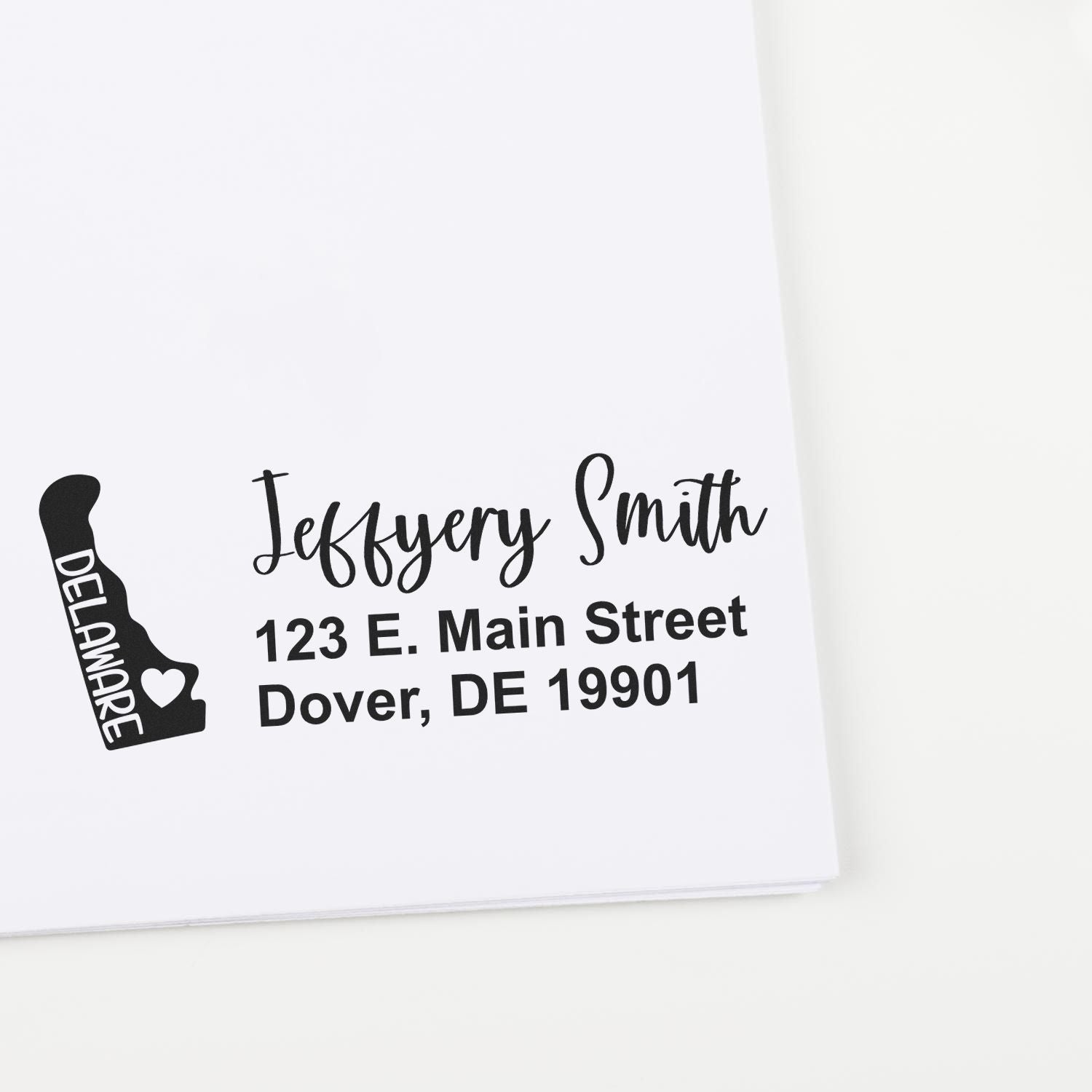 PSI Pre-Inked Delaware State Love Customized Address Stamp on white paper, featuring a Delaware state outline with a heart and personalized address in elegant black font.