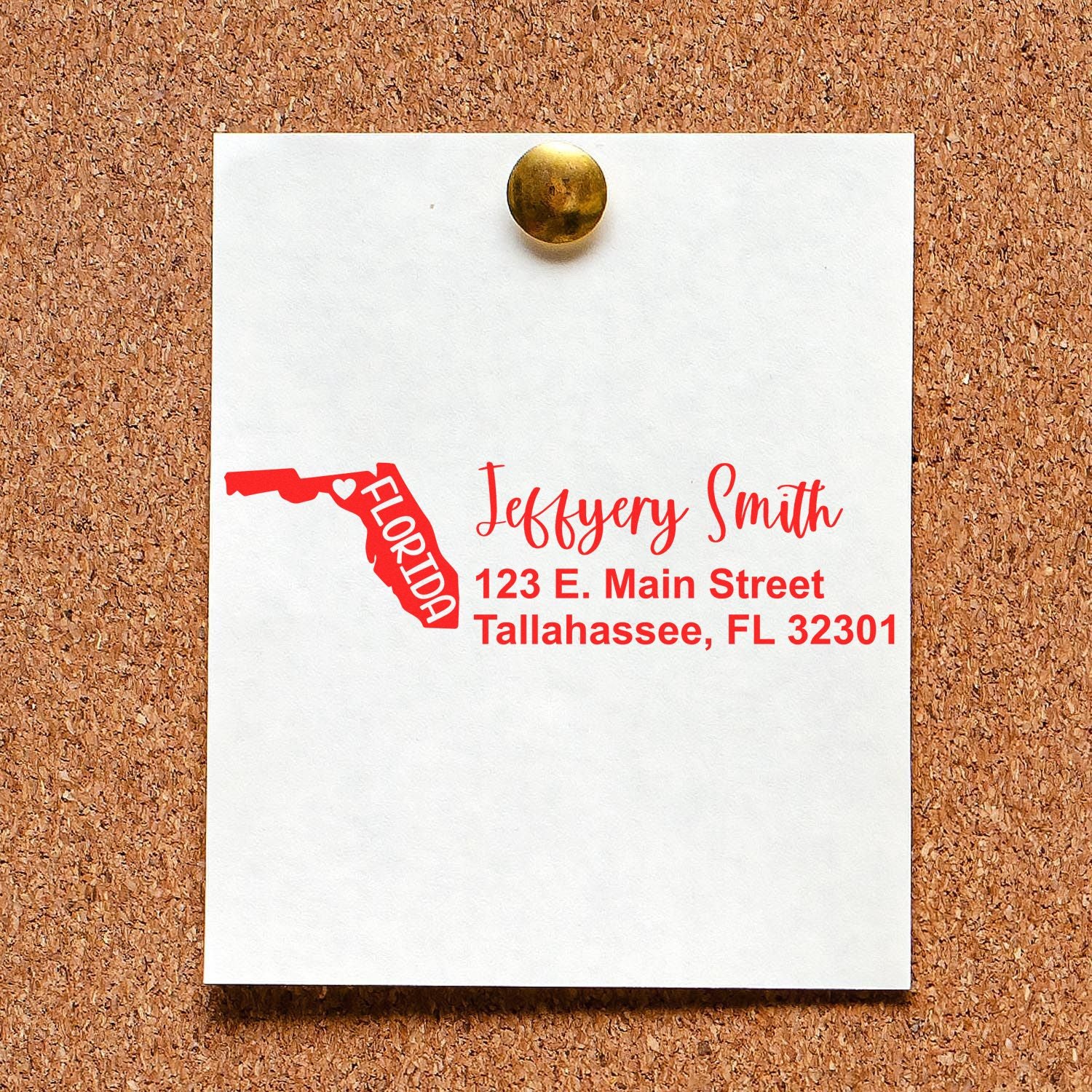 State Love of Florida Custom Address Stamp Self-Inking displayed on a corkboard, featuring a red Florida map outline and personalized address in elegant script.